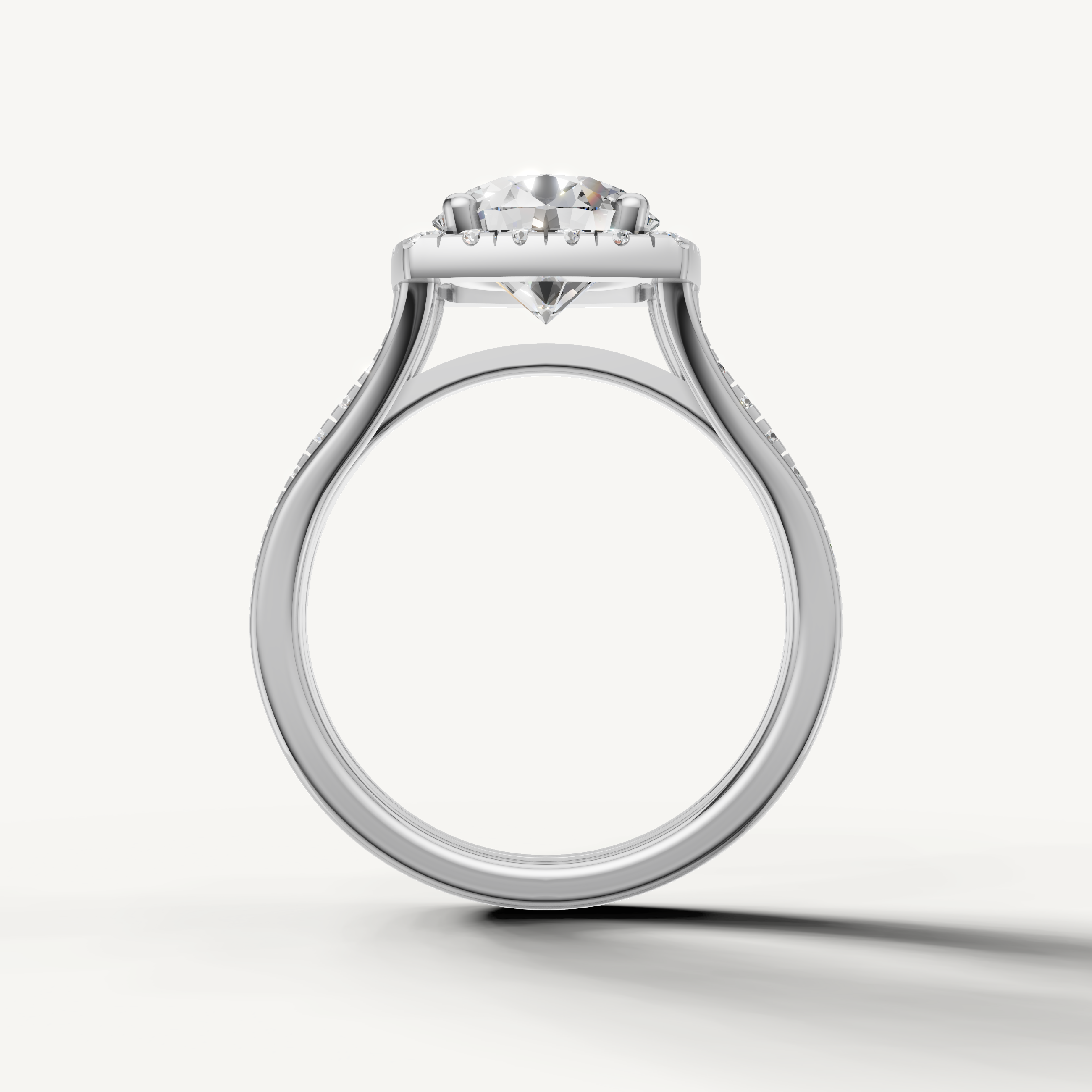 White gold round cut engagement ring with cushion style halo by Raul Diamonds.