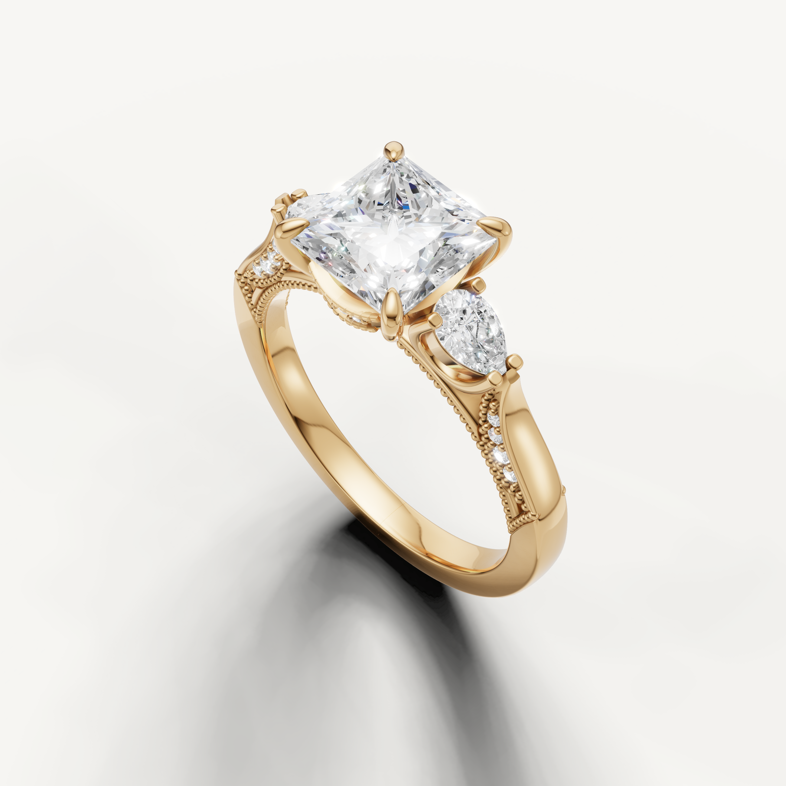 Princess cut solitaire diamond ring with pear side stones yellow gold elegant design