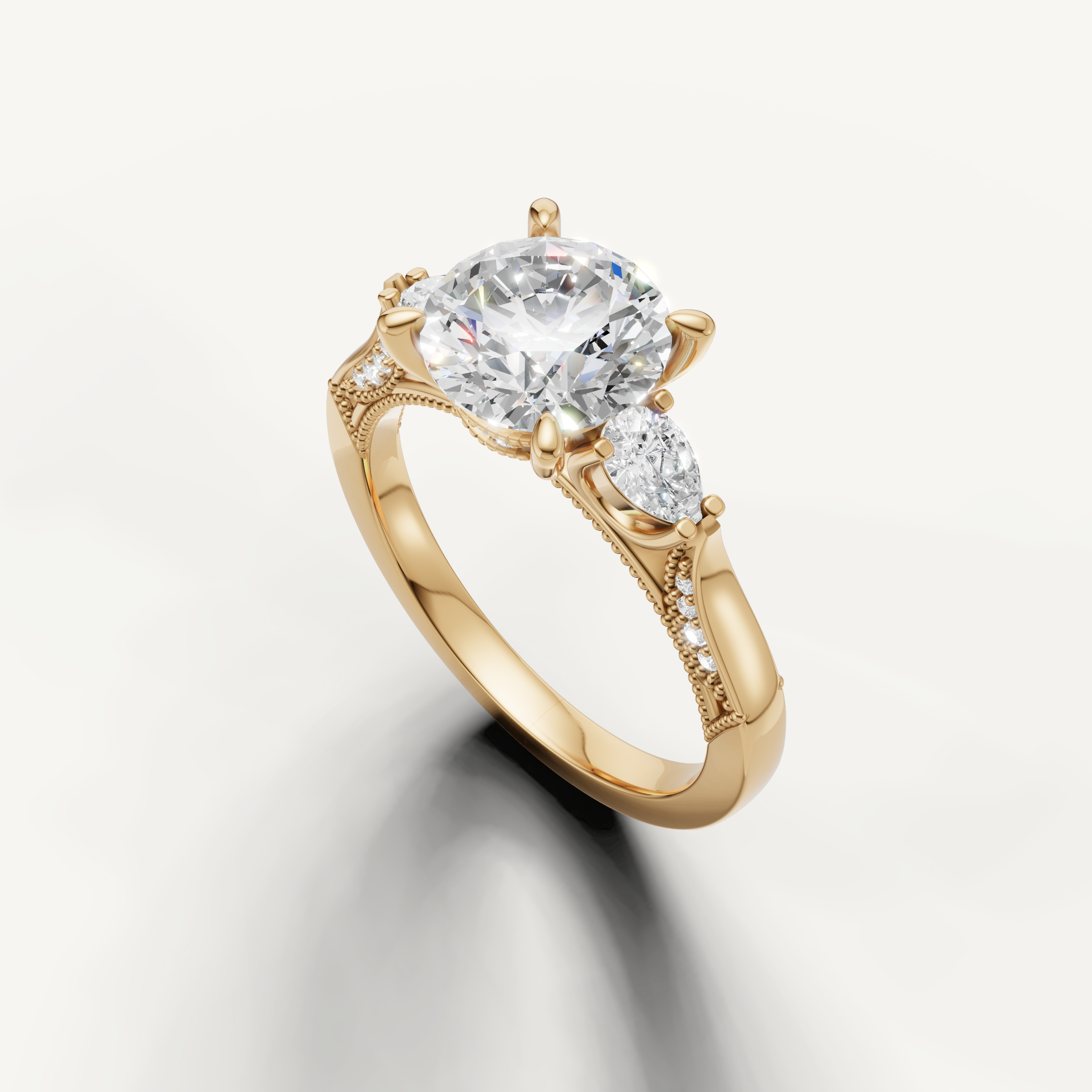 Round brilliant diamond ring with pear side stones yellow gold elegant design