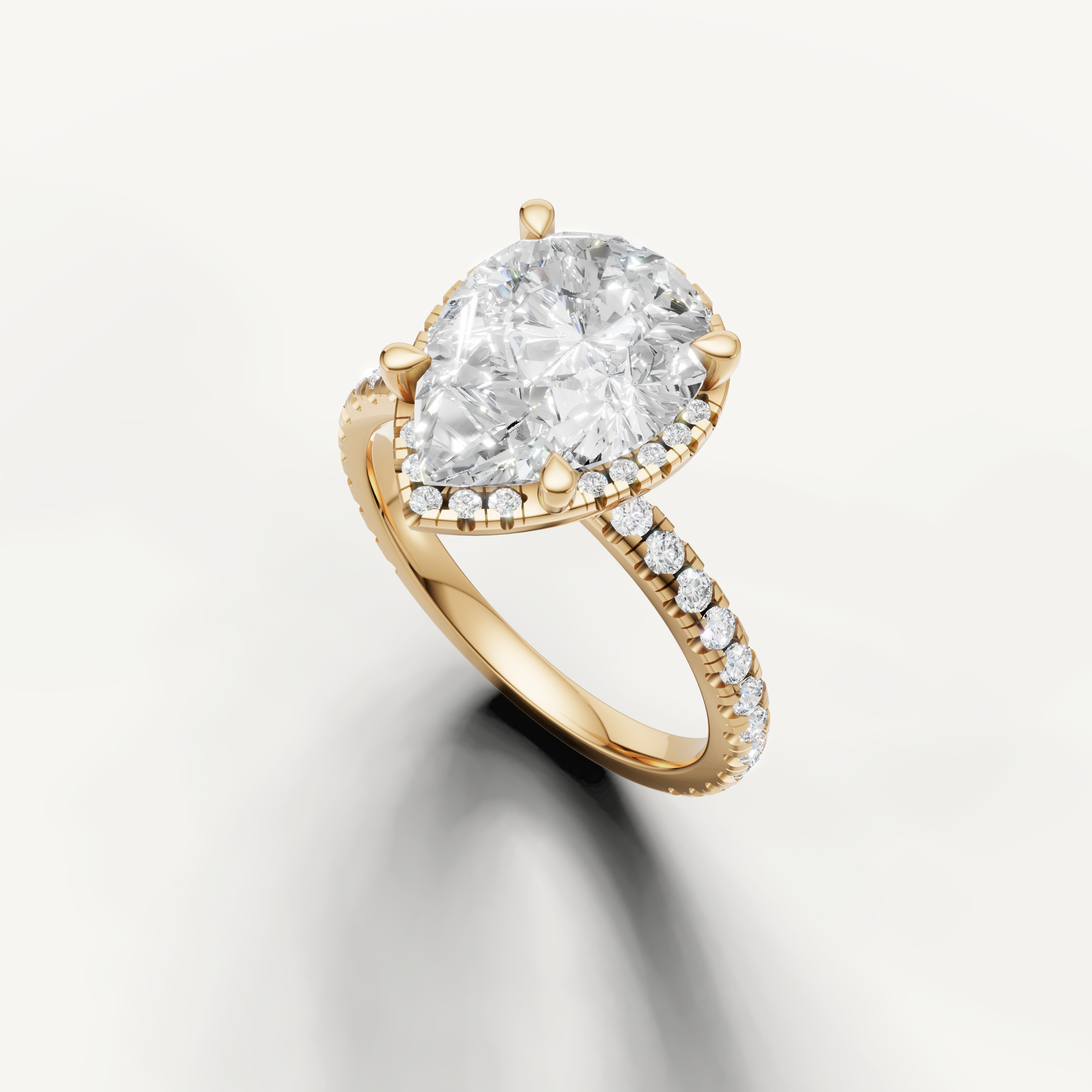 Teardrop lab diamond engagement ring with hidden halo and pavé band yellow gold