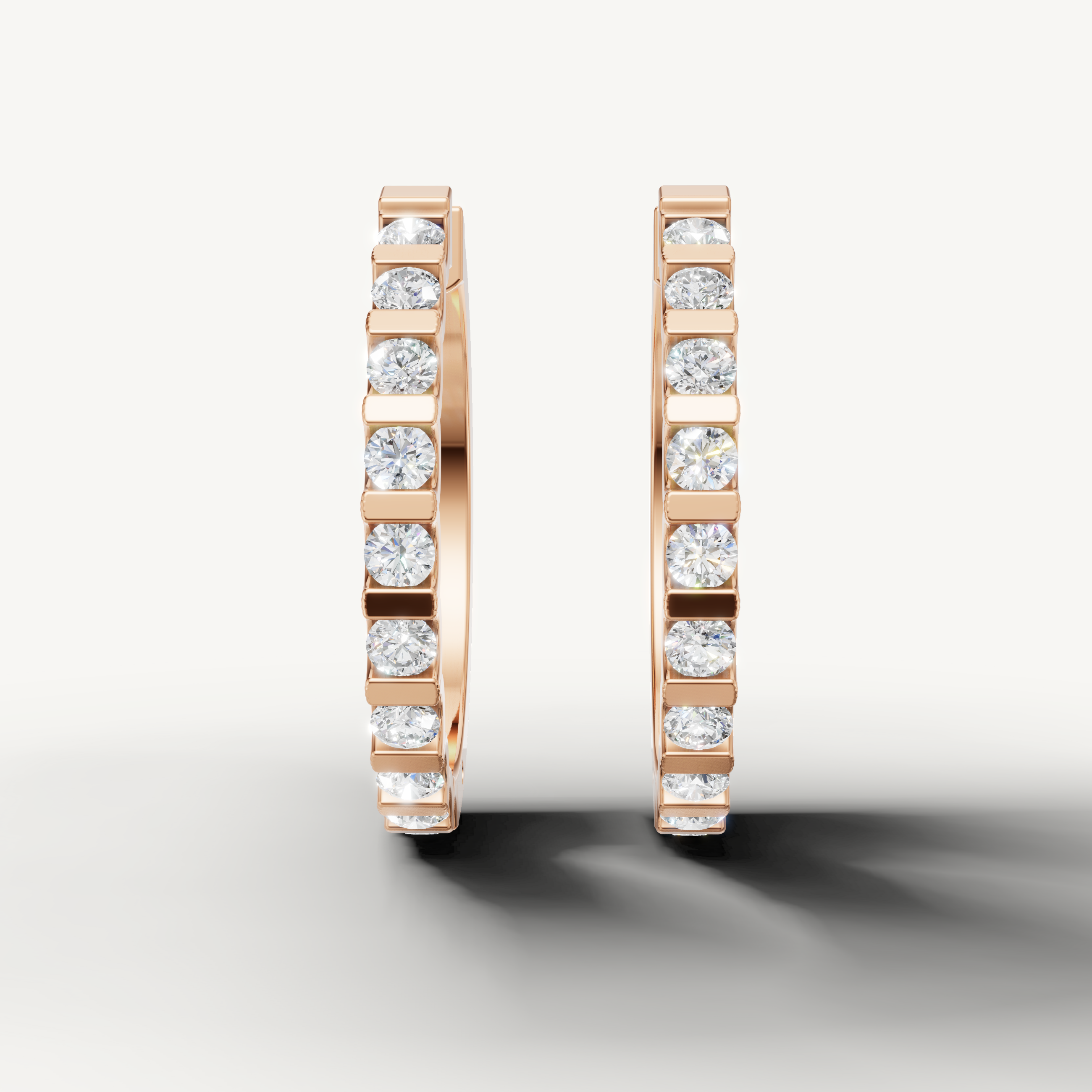 Rose gold bezel diamond huggie earrings by Raul Diamonds featuring elegant luxury craftsmanship