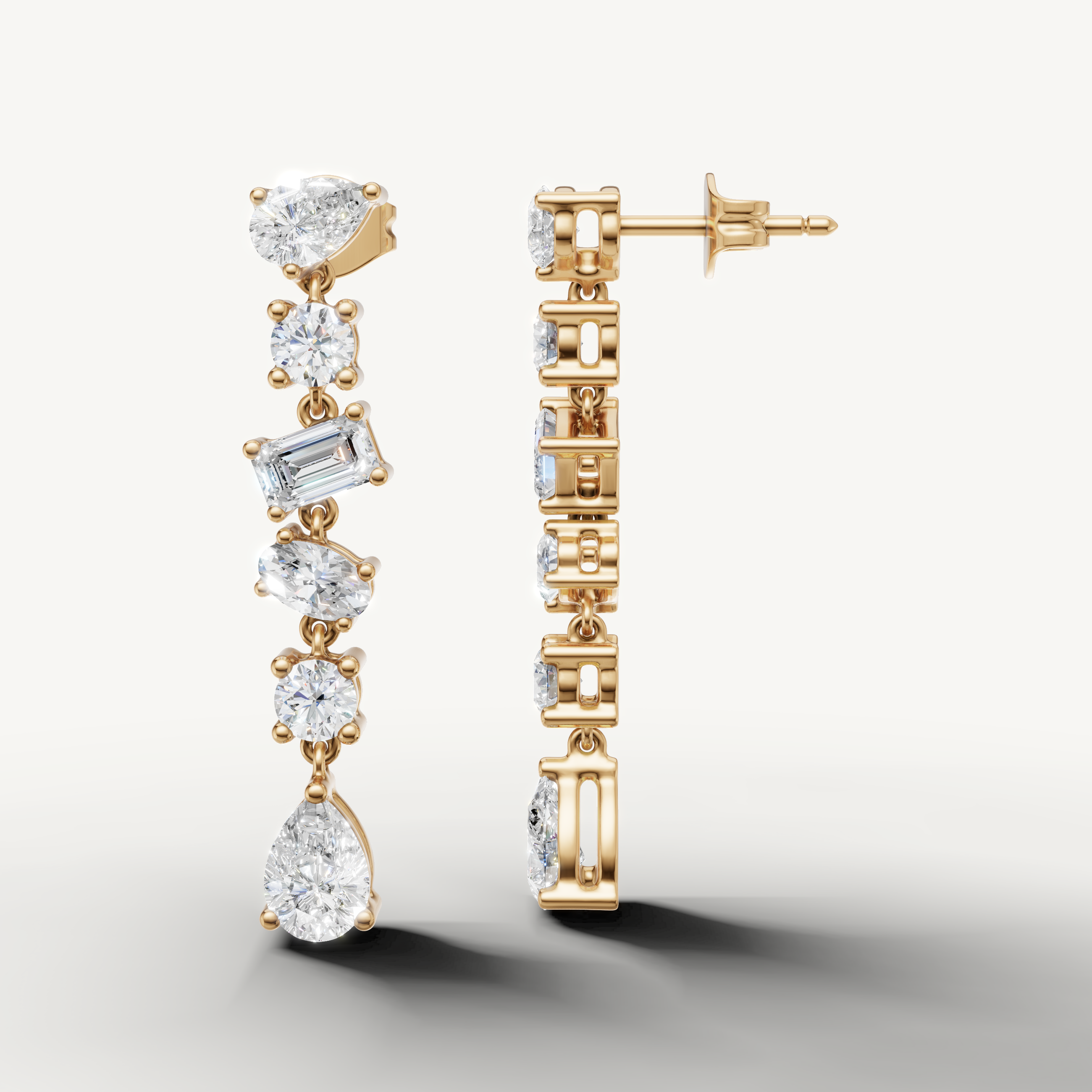 Yellow gold pear and emerald cut diamond dangle earrings by Raul Diamonds