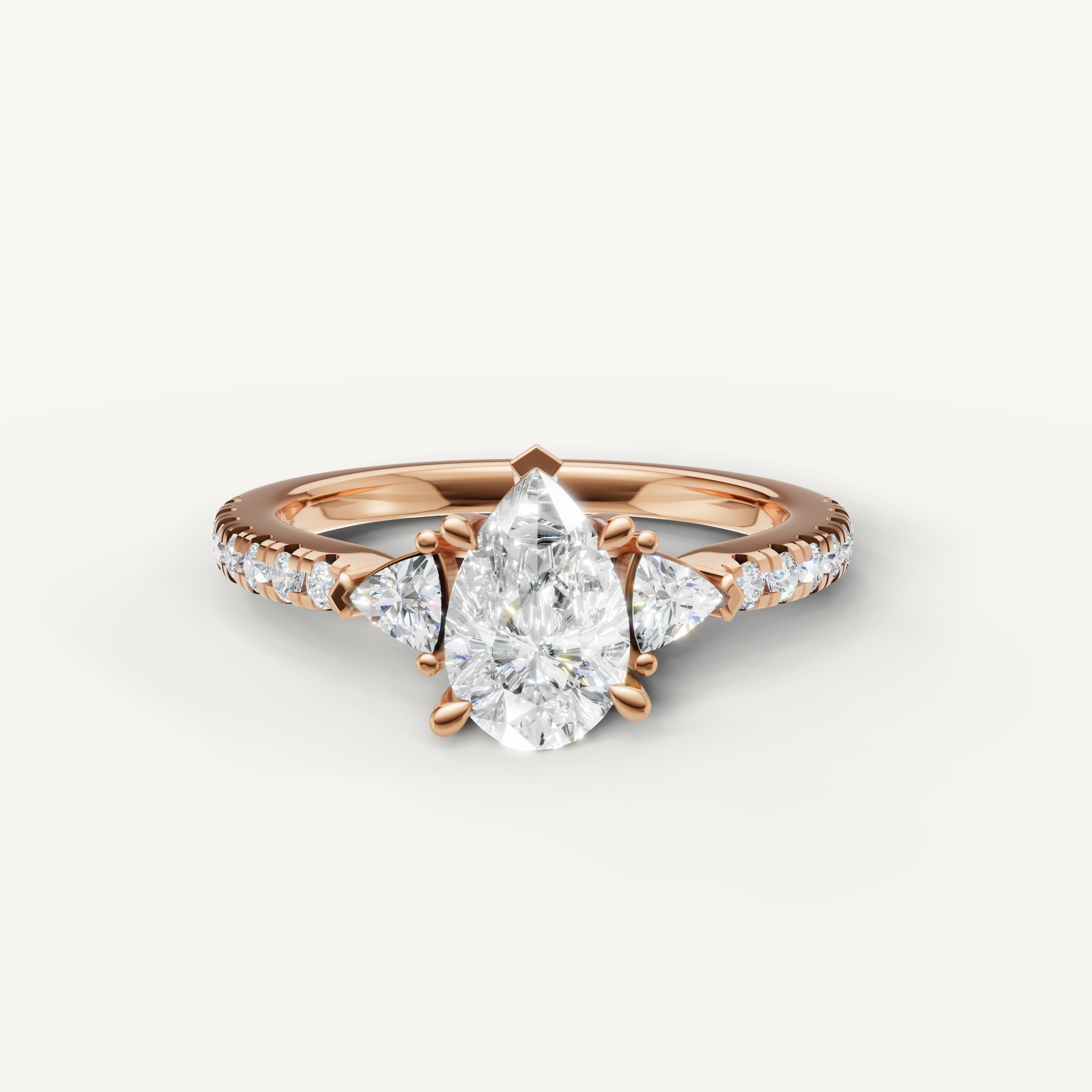 Pear cut lab grown diamond engagement ring in 14K rose gold with pavé band and side diamonds