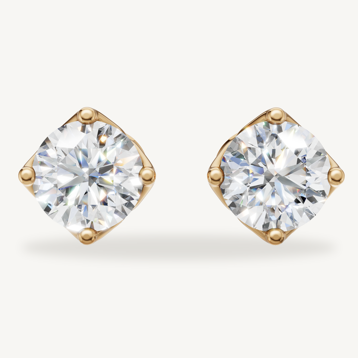 Round lab grown diamond stud earrings in 14K yellow gold by Raul Diamonds