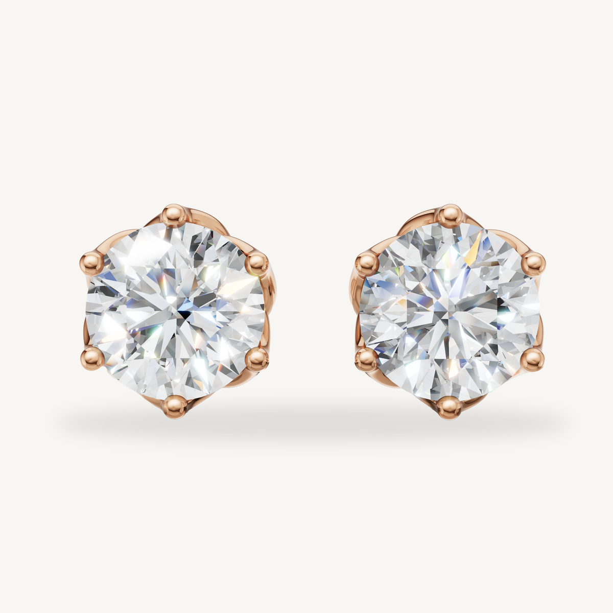 Round lab grown diamond stud earrings in 14K rose gold by Raul Diamonds