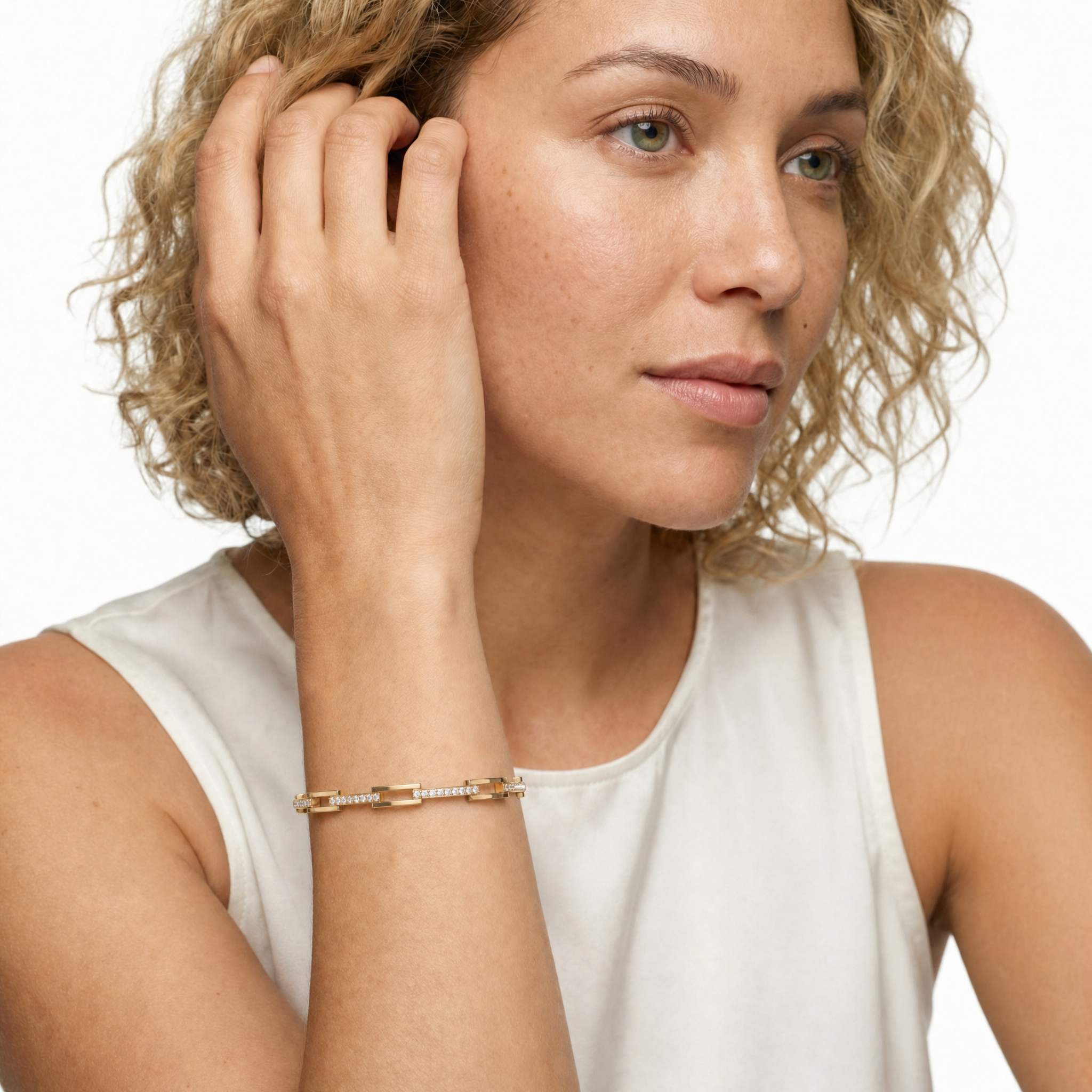 Sophisticated female model wearing a yellow gold geometric diamond bracelet by Raul Diamonds featuring sleek open-link styling with sparkling lab grown diamonds