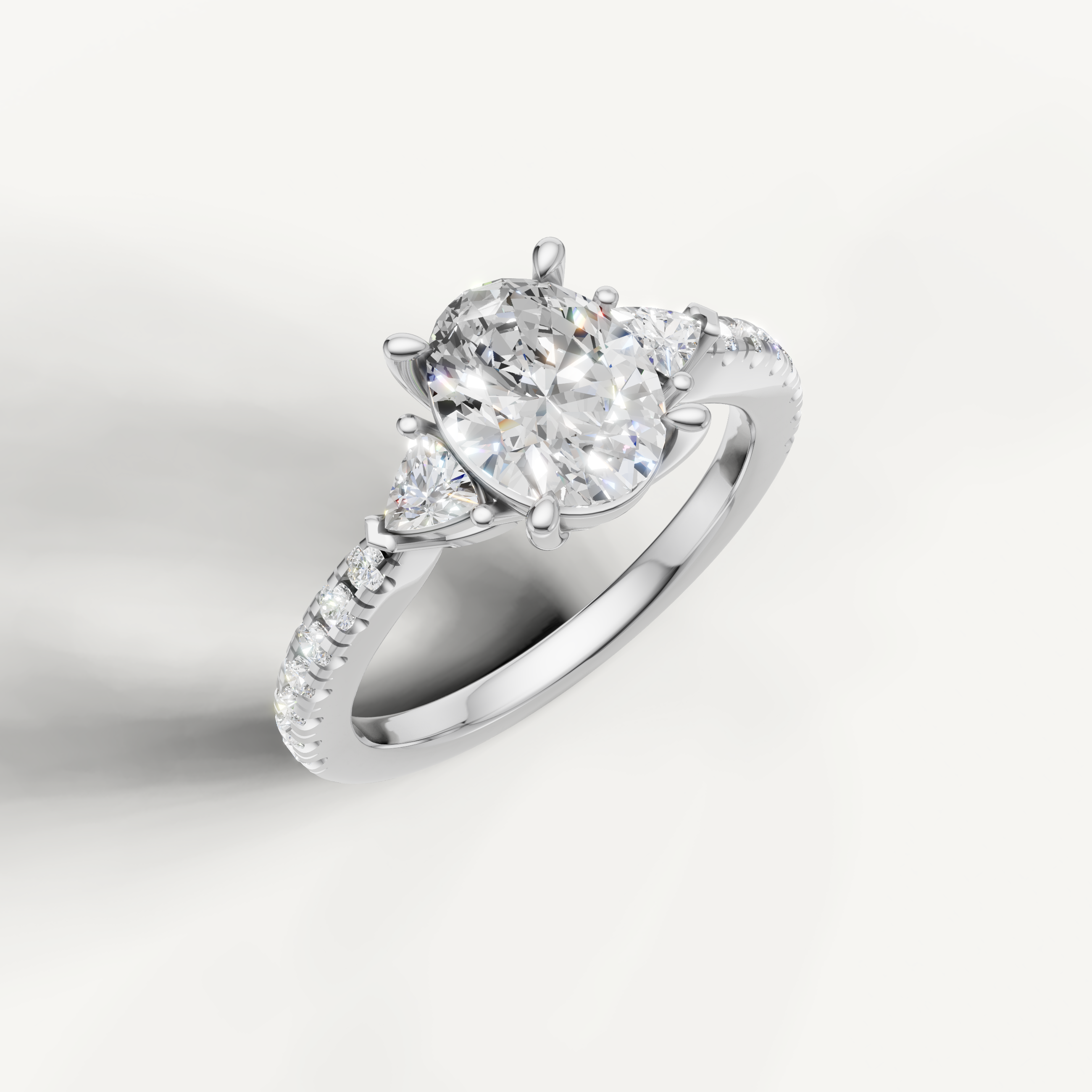 Three-stone oval cut lab grown diamond ring with pavé band in 14K gold