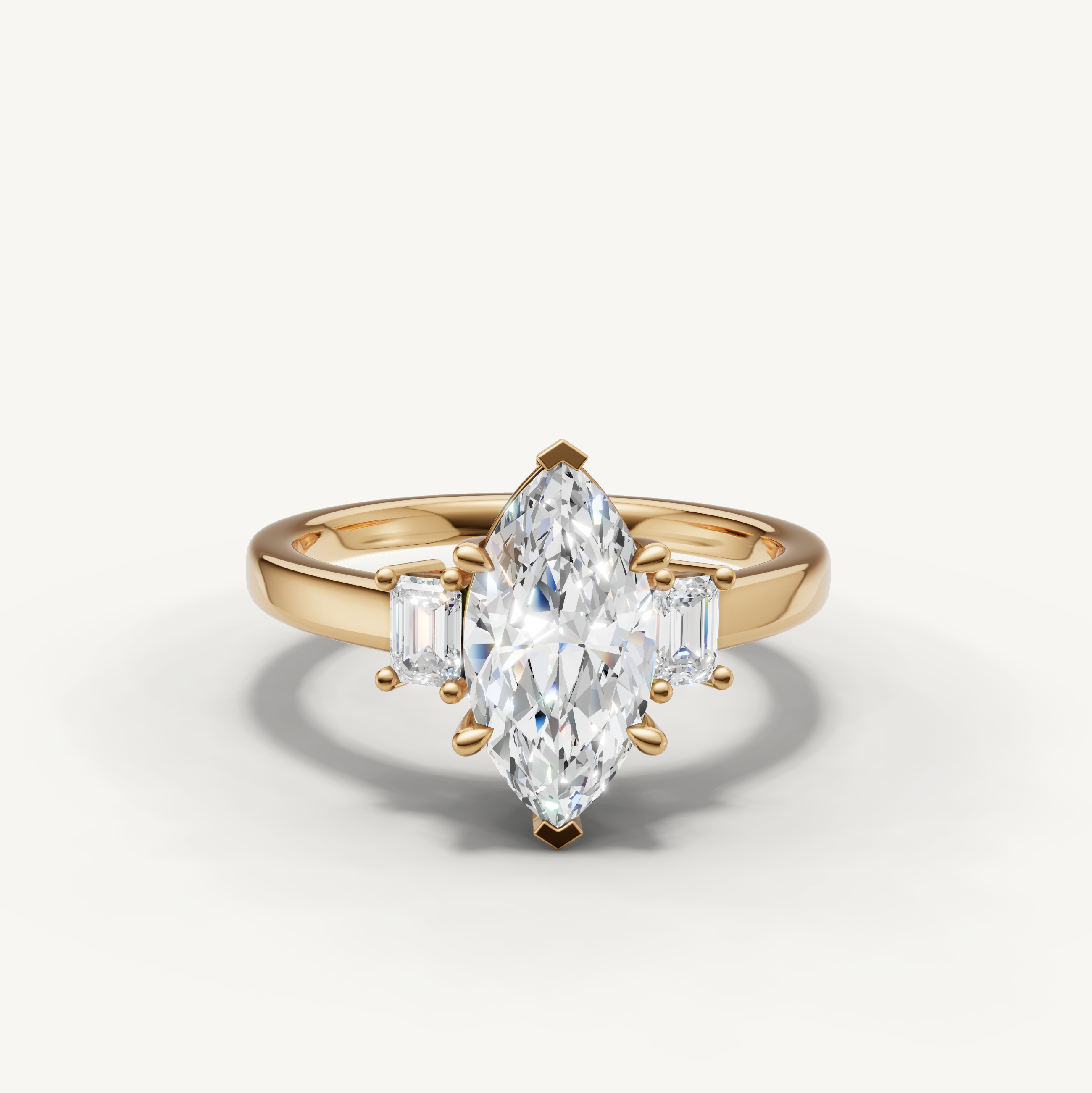 14K yellow gold marquise lab grown diamond ring with tapered baguette side diamonds and sleek band