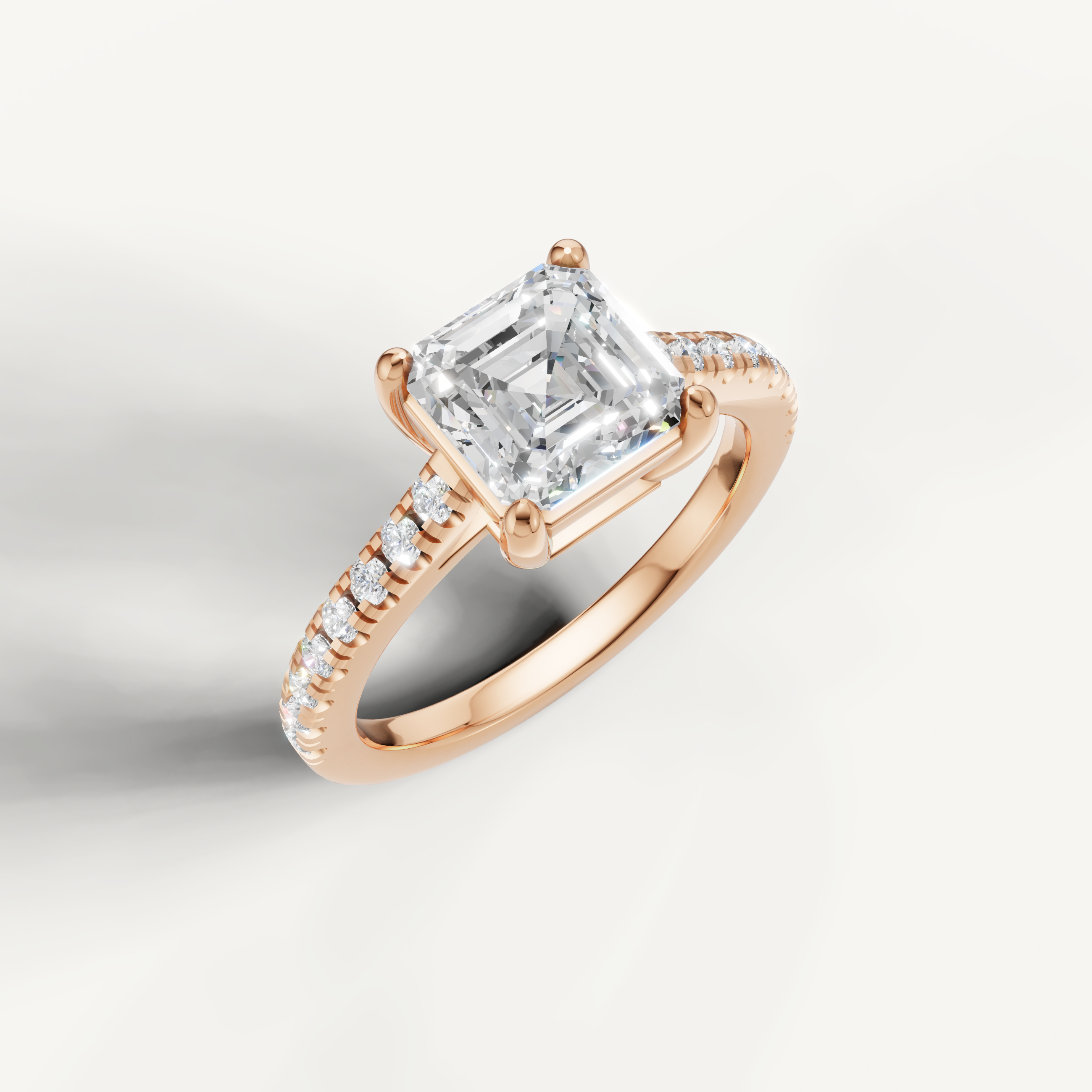 Rose gold emerald cut solitaire engagement ring by Raul Diamonds with luxury sparkle