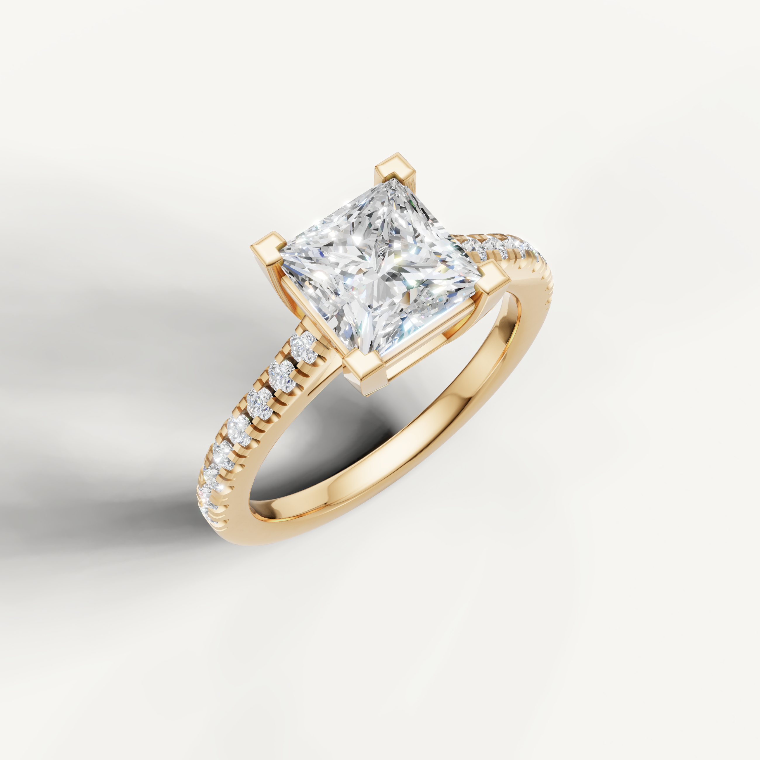 Yellow gold princess cut solitaire engagement ring by Raul Diamonds with sparkling pavé diamonds