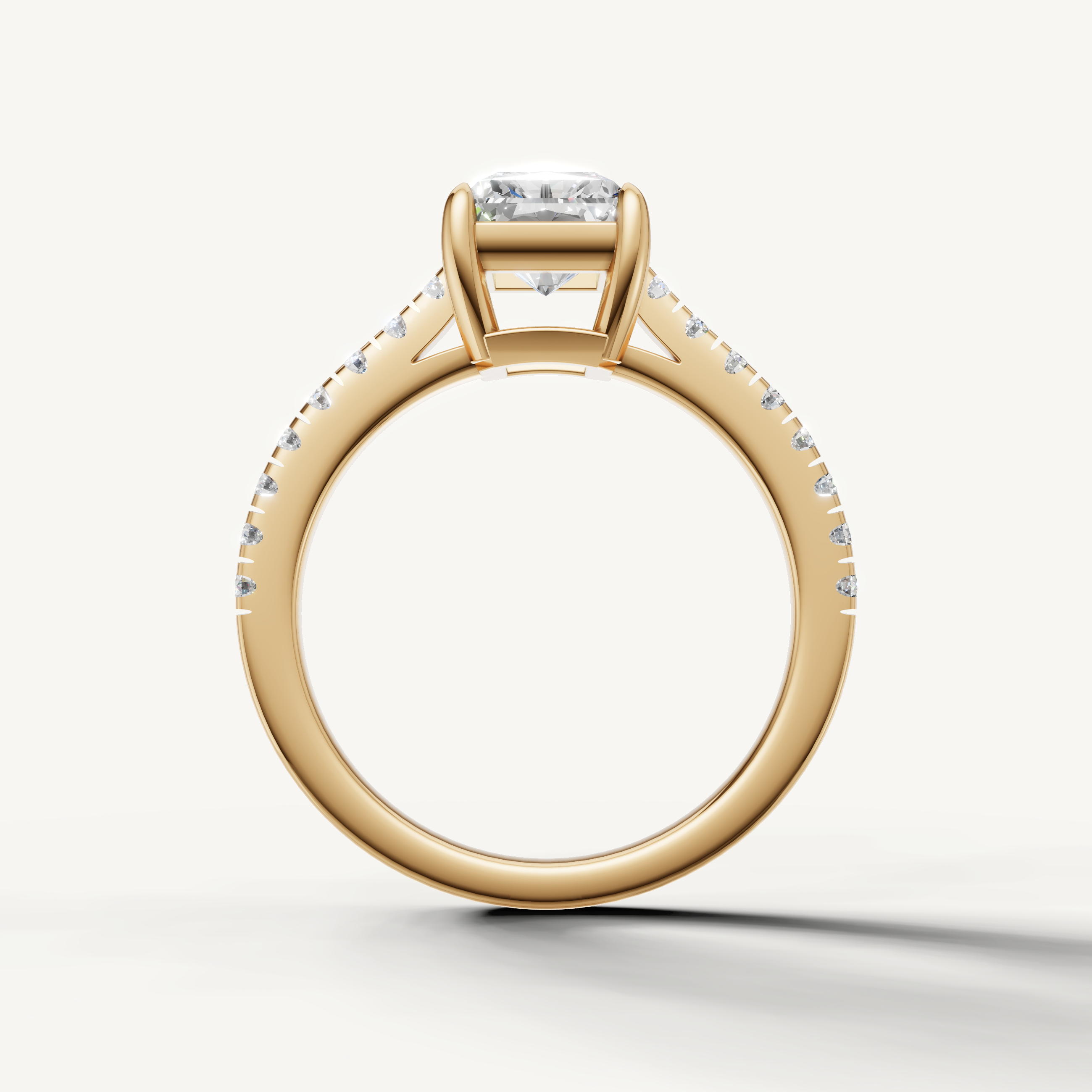 Radiant cut engagement ring in yellow gold with slim pavé diamond band