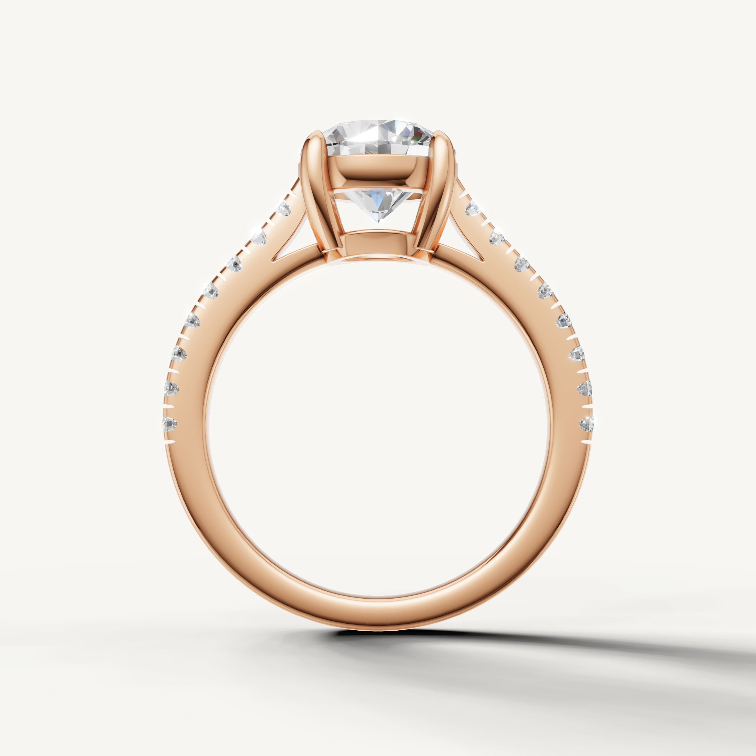 Round brilliant diamond ring in rose gold with thin pavé band