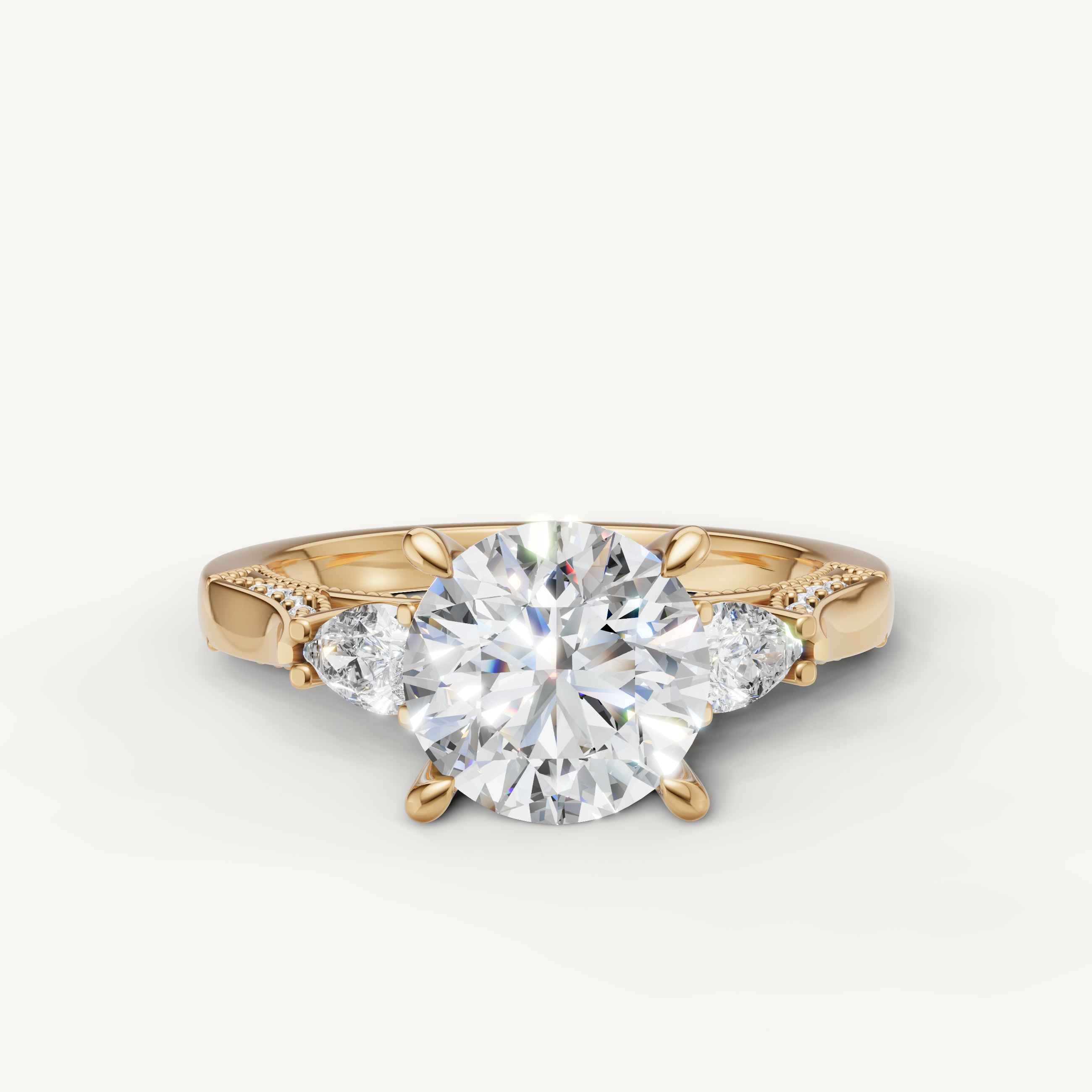 Raul Diamonds yellow gold round cut diamond engagement ring with pear side stones