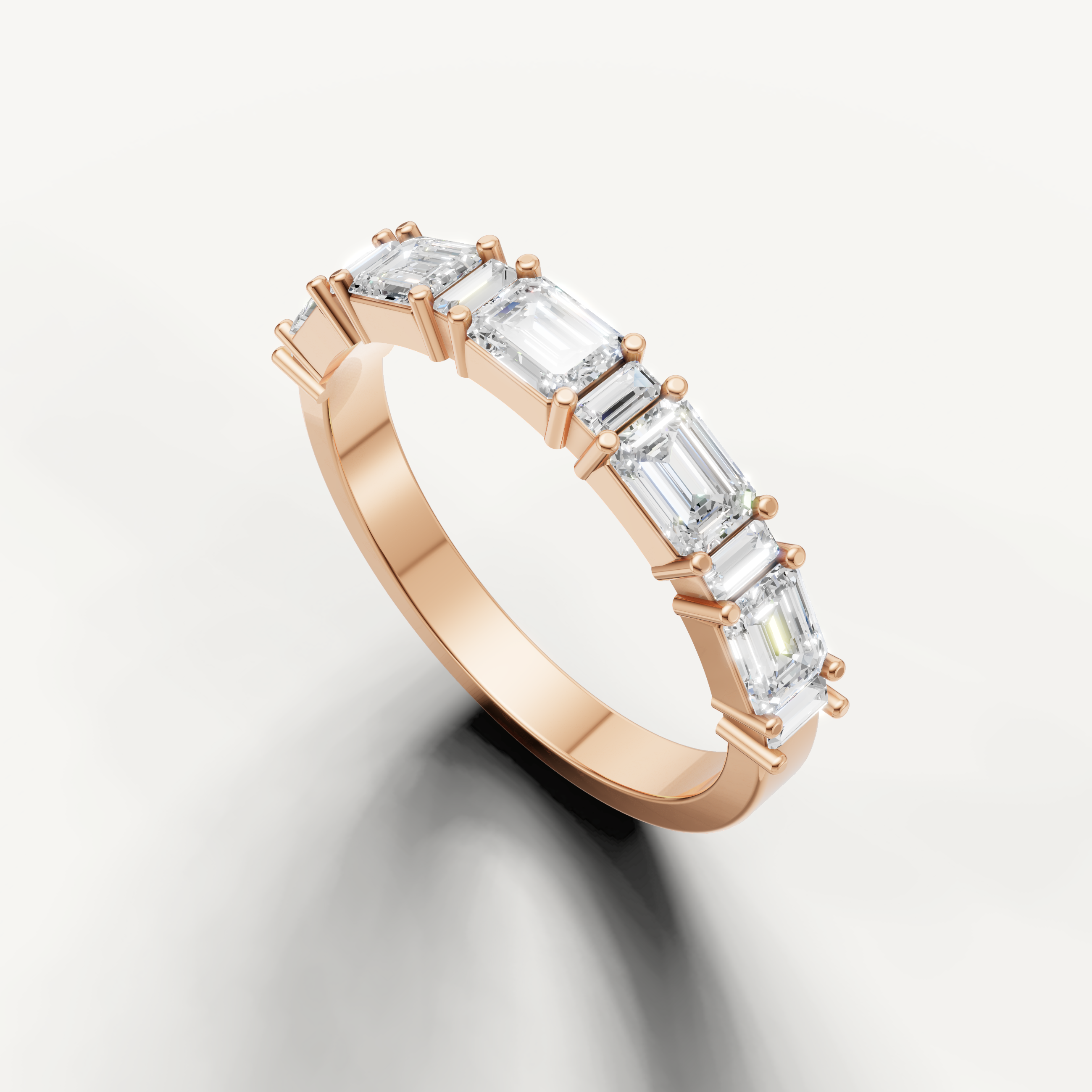 Elegant rose gold wedding ring featuring step cut emerald diamonds from Raul Diamonds