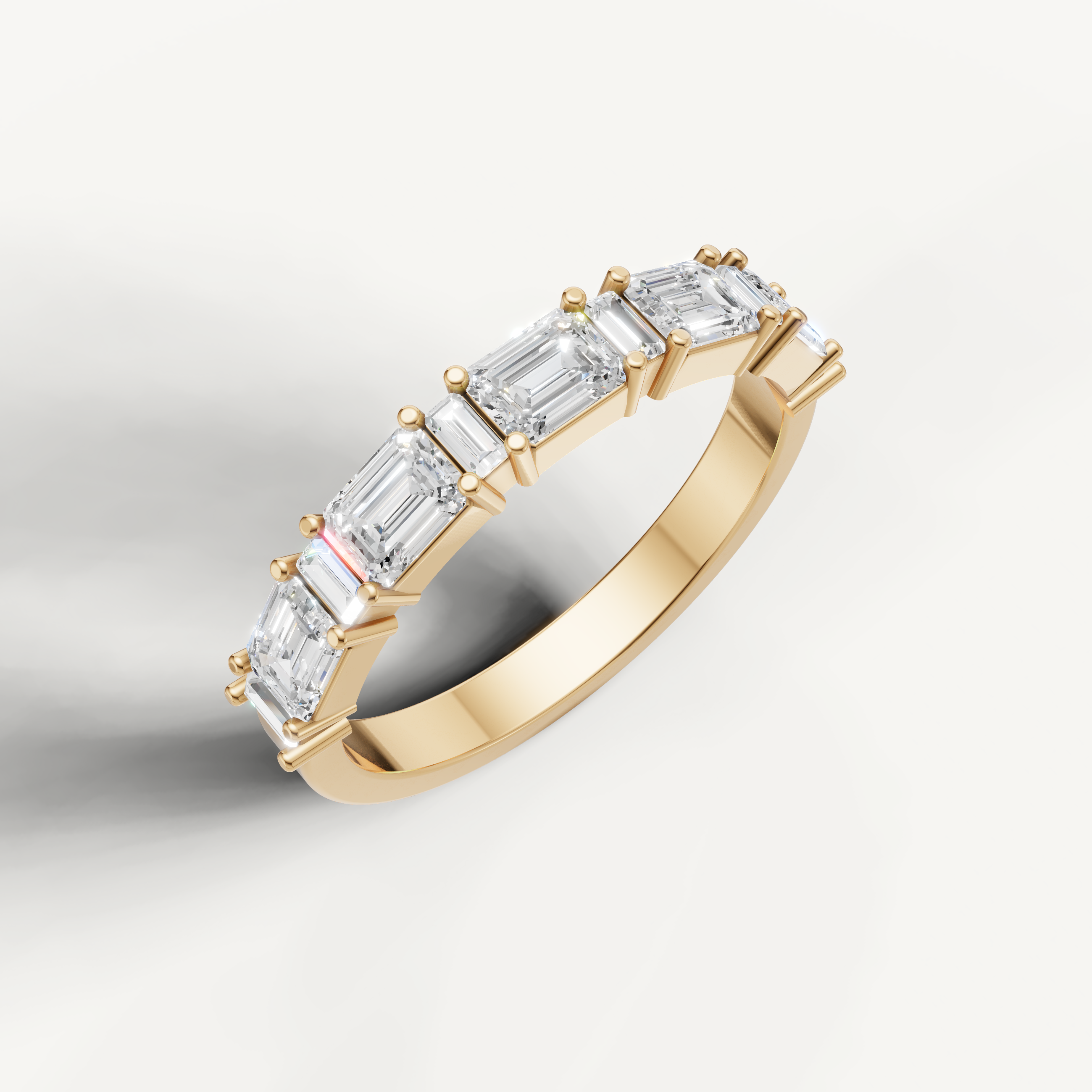 Luxury yellow gold emerald cut diamond wedding band by Raul Diamonds with modern step cut brilliance
