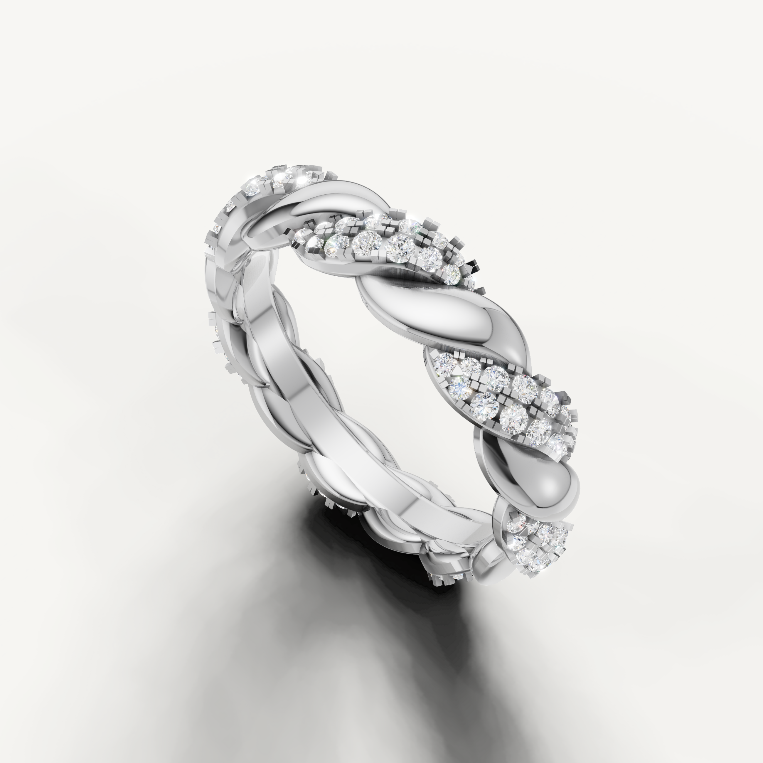 White gold eternity wedding band featuring brilliant pavé diamonds and handcrafted braided styling from Raul Diamonds
