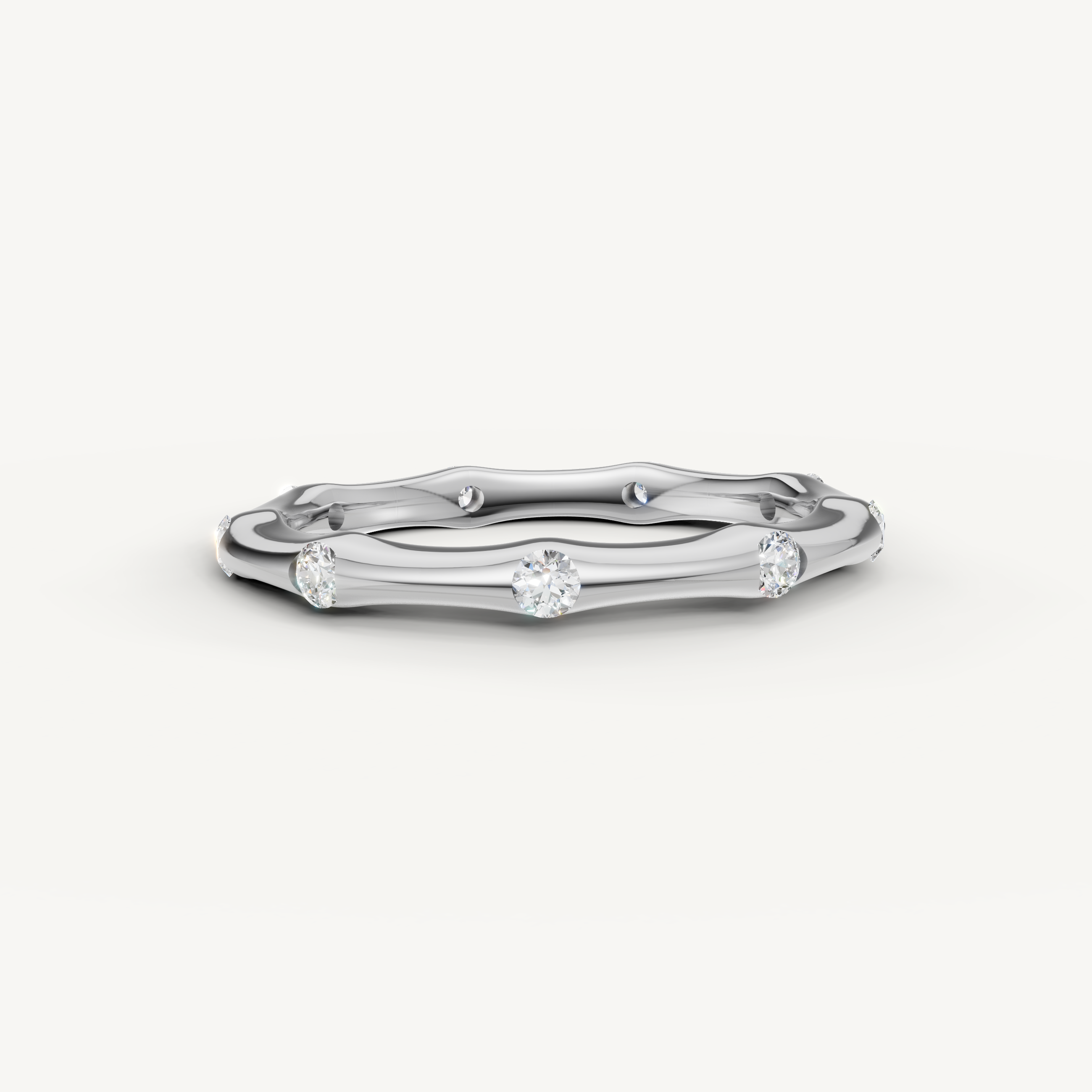 Raul Diamonds white gold curved diamond wedding band with bezel set round diamonds and sleek modern design