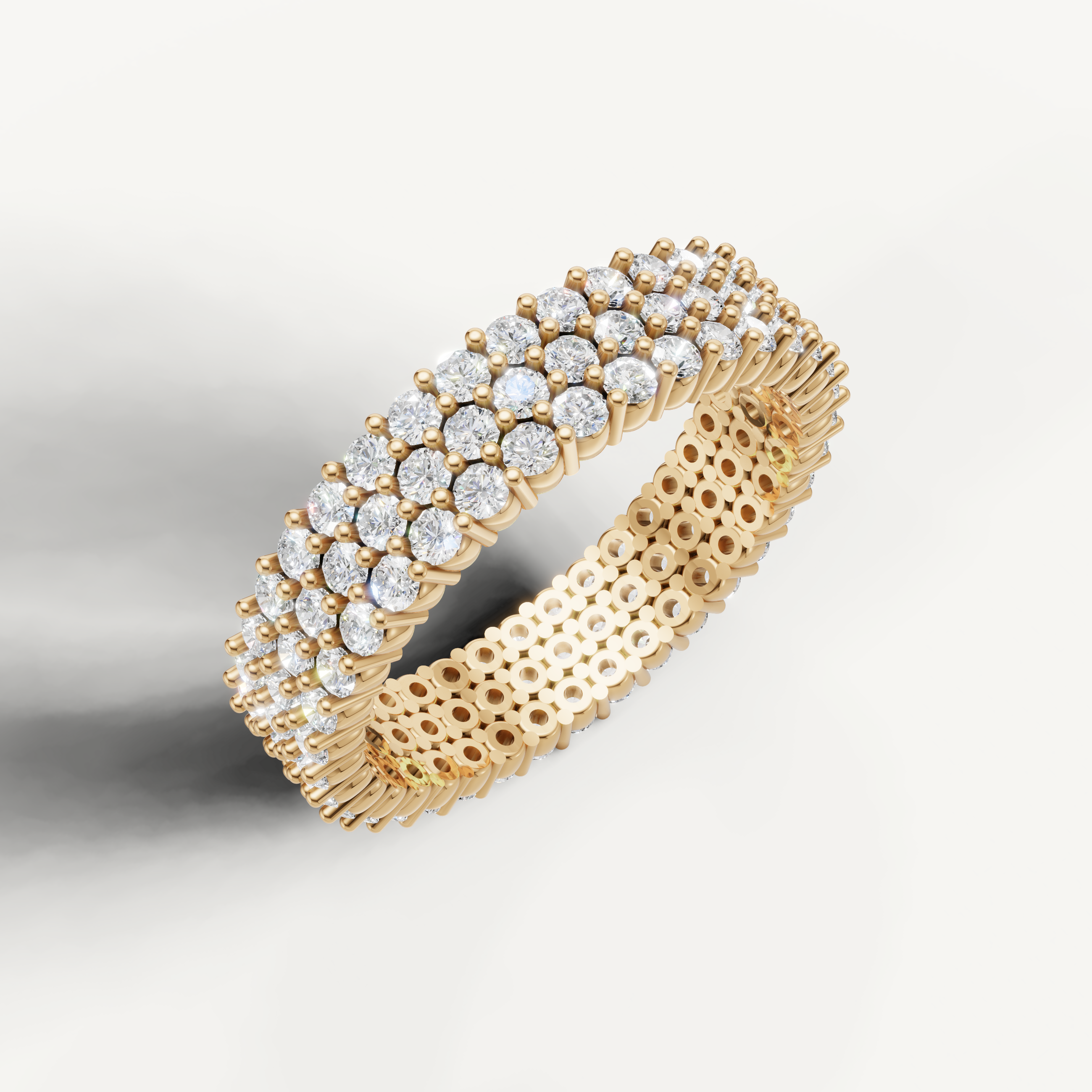 Elegant yellow gold diamond eternity wedding ring featuring triple row pavé diamonds by Raul Diamonds