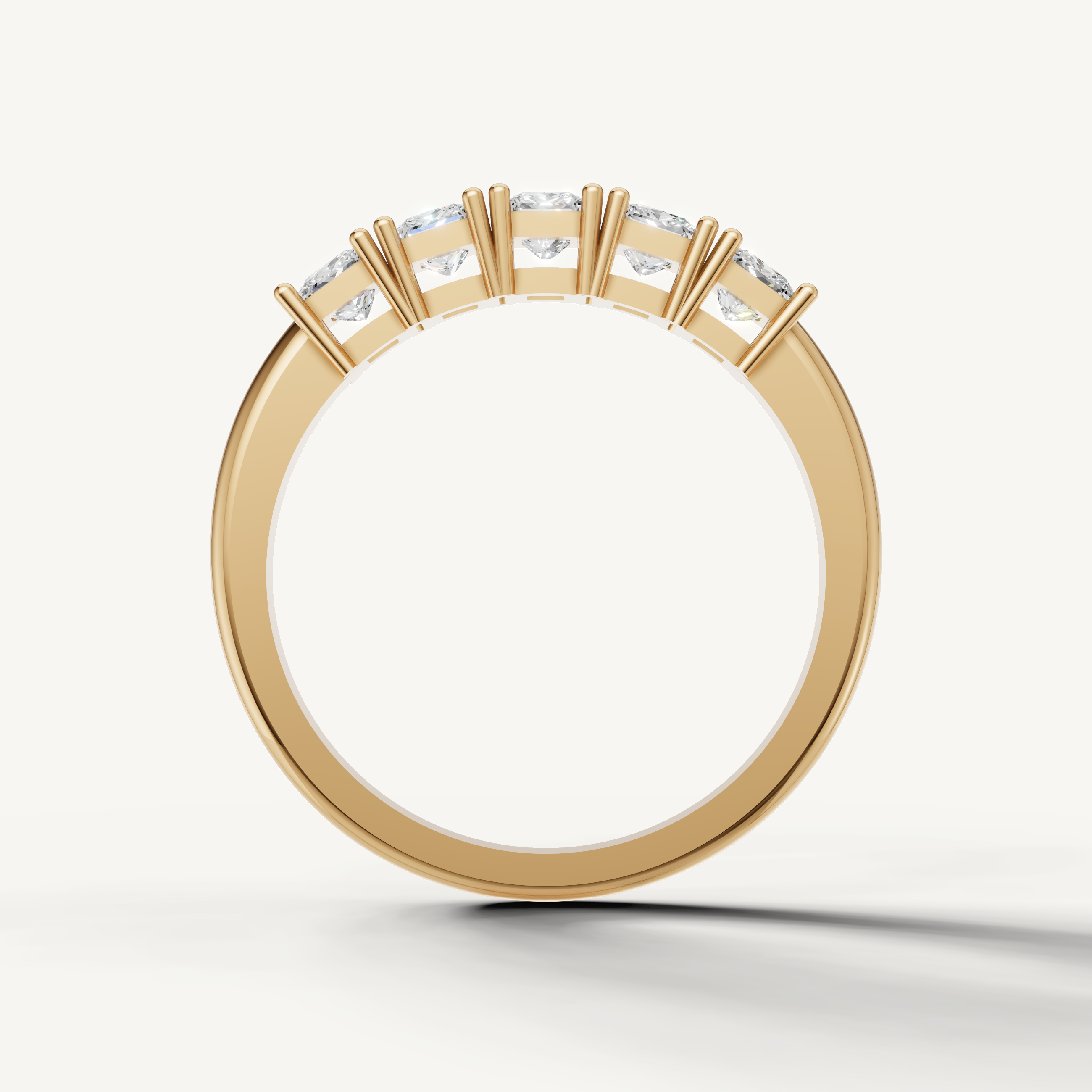 Modern yellow gold princess diamond wedding ring with shared prong setting by Raul Diamonds