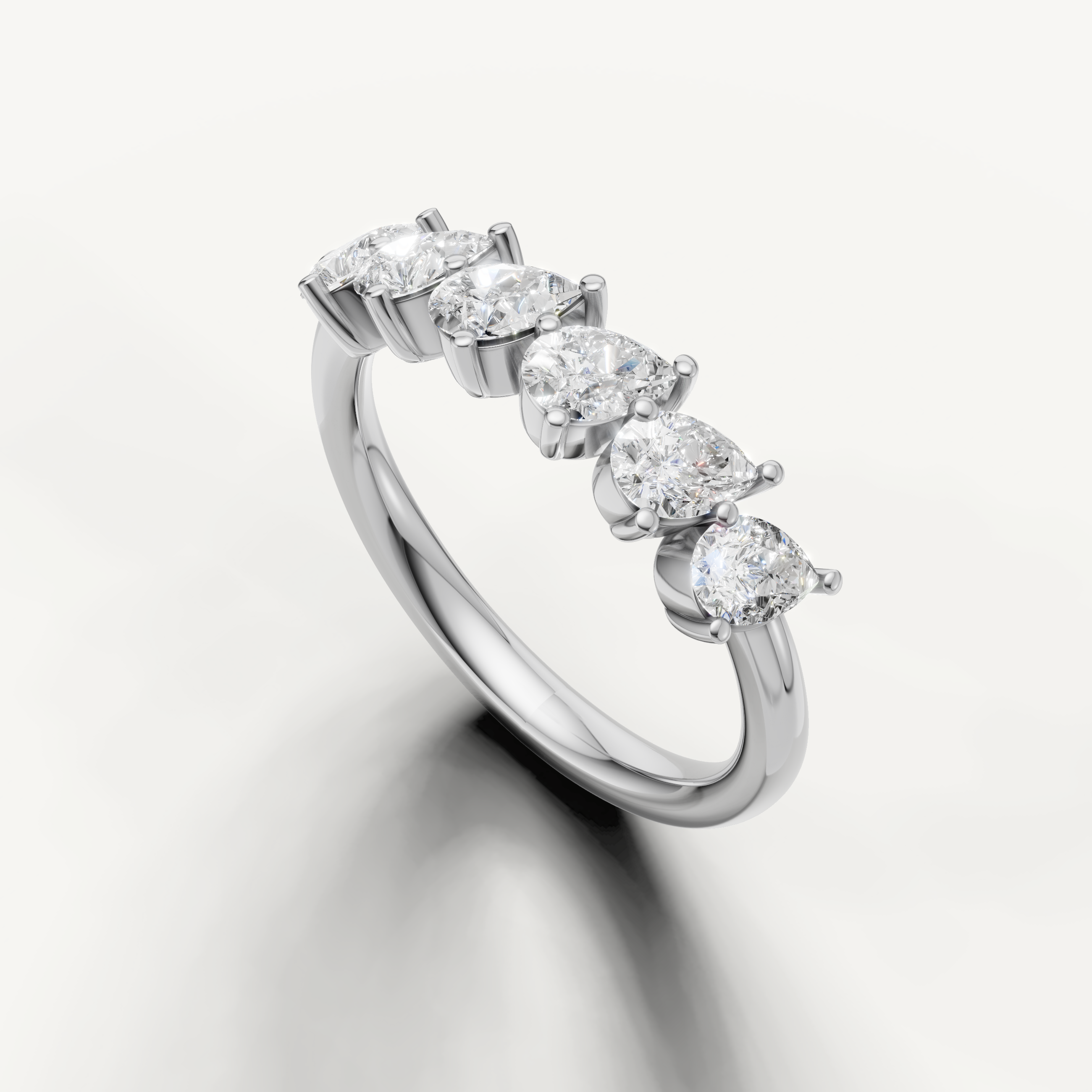 Classic white gold wedding band with brilliant pear cut diamonds by Raul Diamonds