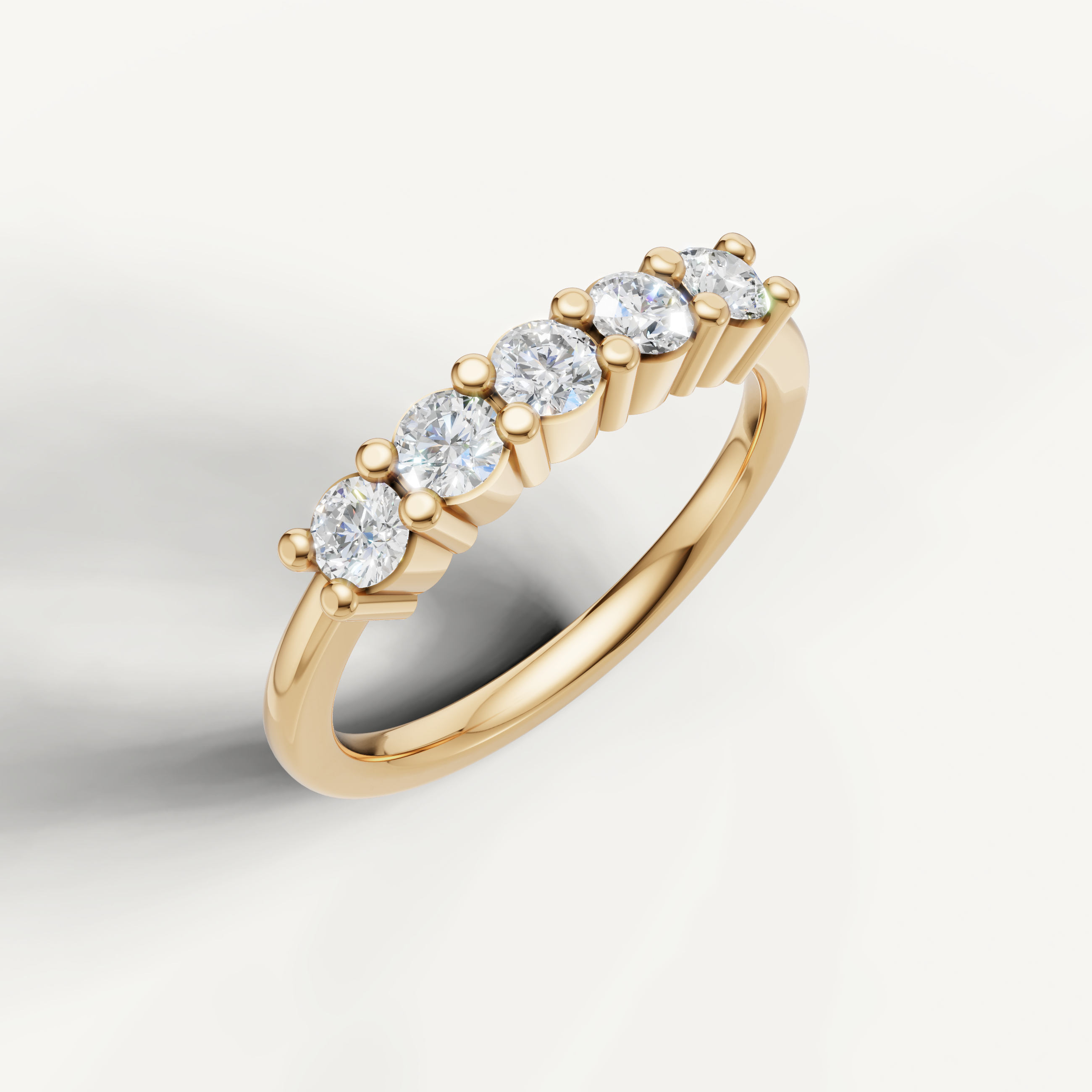 Elegant yellow gold diamond wedding band featuring five round cut diamonds by Raul Diamonds
