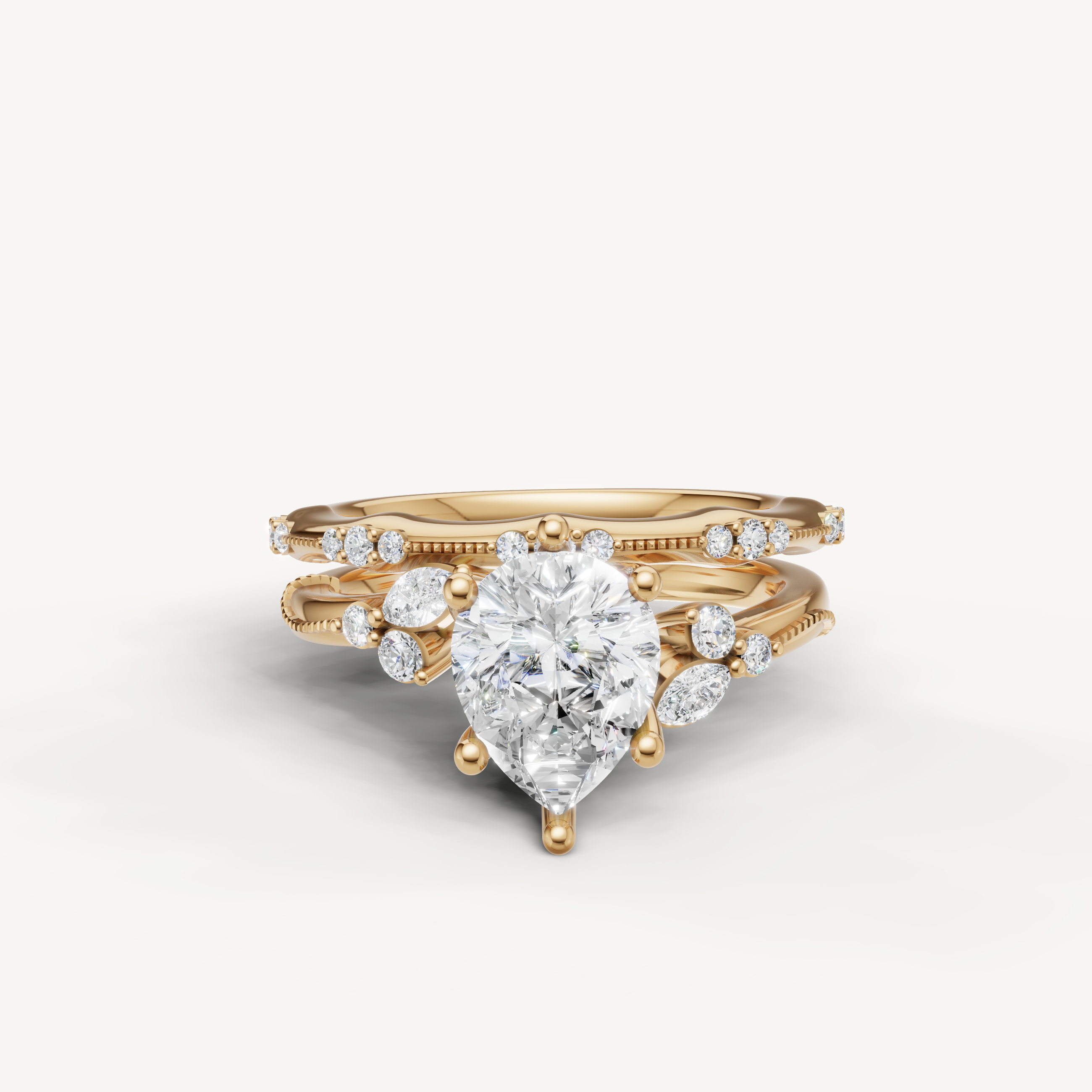 Raul Diamonds yellow gold pear cut diamond bridal set with matching wedding bands