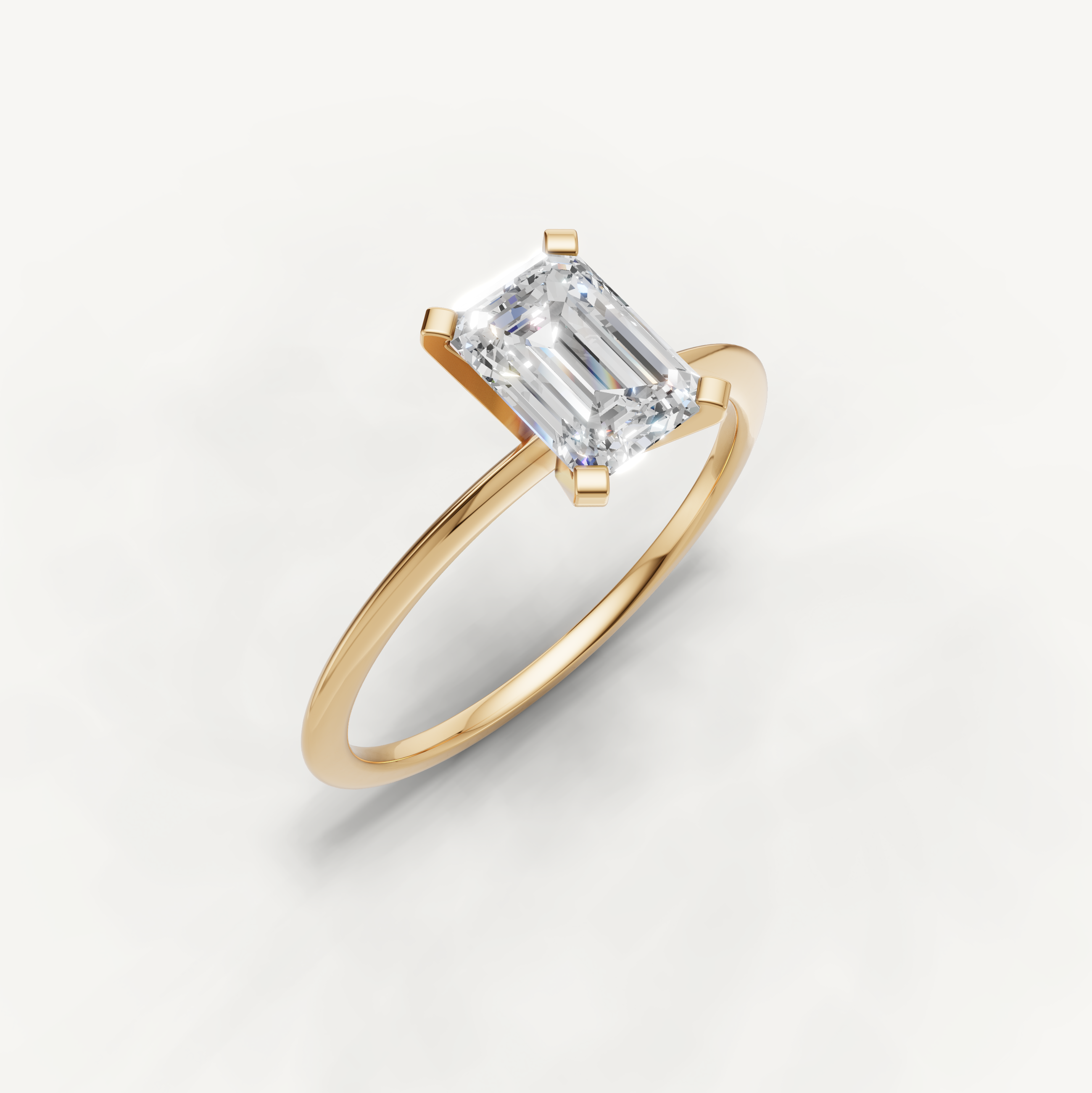 Elegant emerald cut yellow gold solitaire ring for women by Raul Diamonds