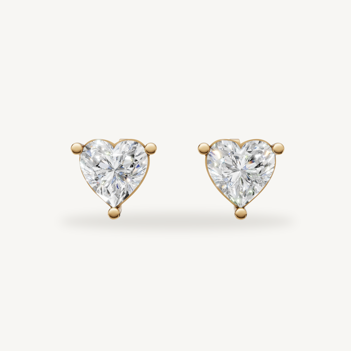 Raul Diamonds yellow gold heart diamond stud earrings with brilliant solitaire sparkle