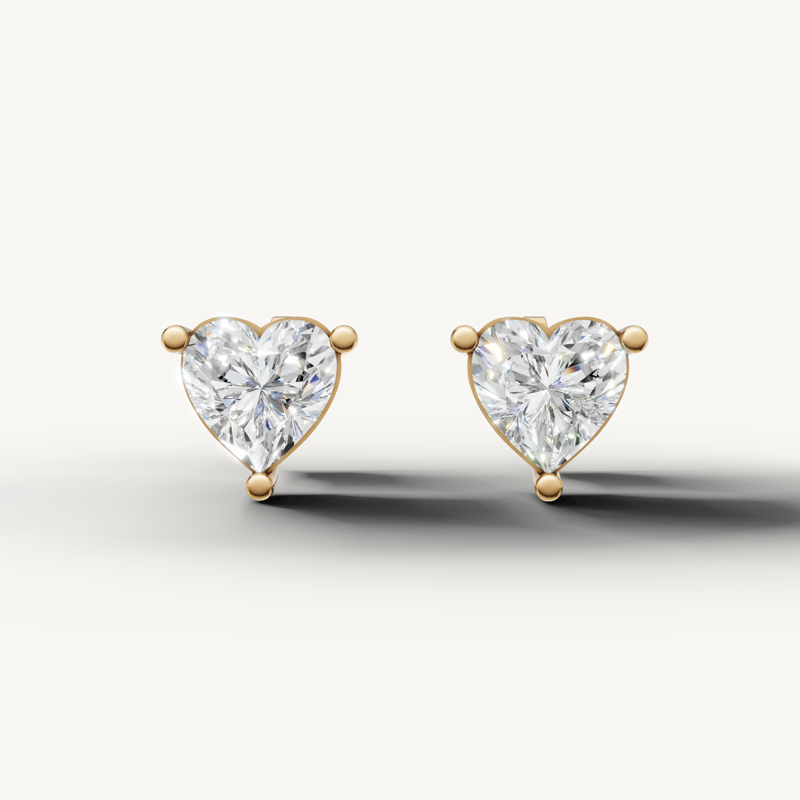 Raul Diamonds yellow gold heart diamond stud earrings with brilliant solitaire sparkle