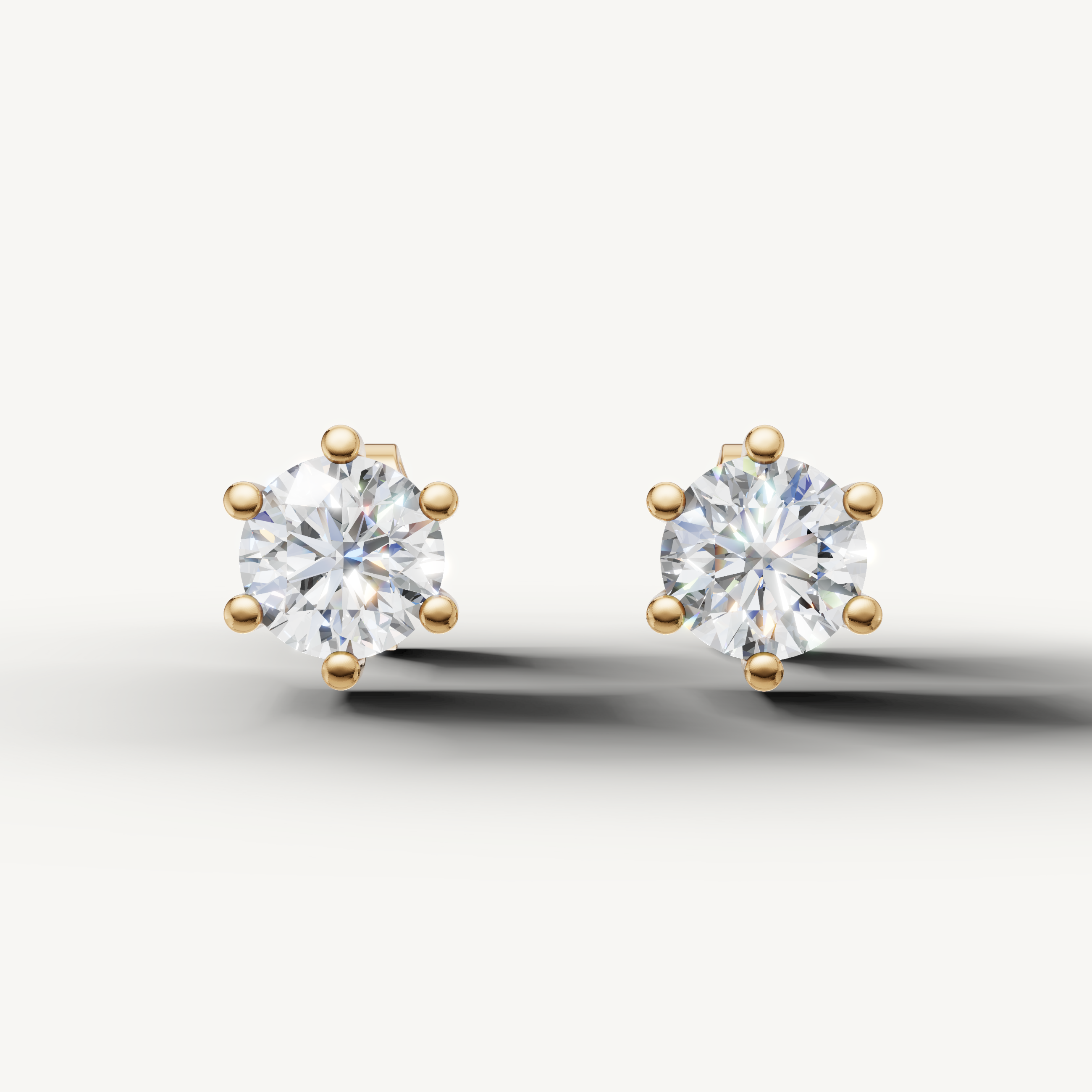 Raul Diamonds yellow gold round diamond stud earrings with classic six prong solitaire setting