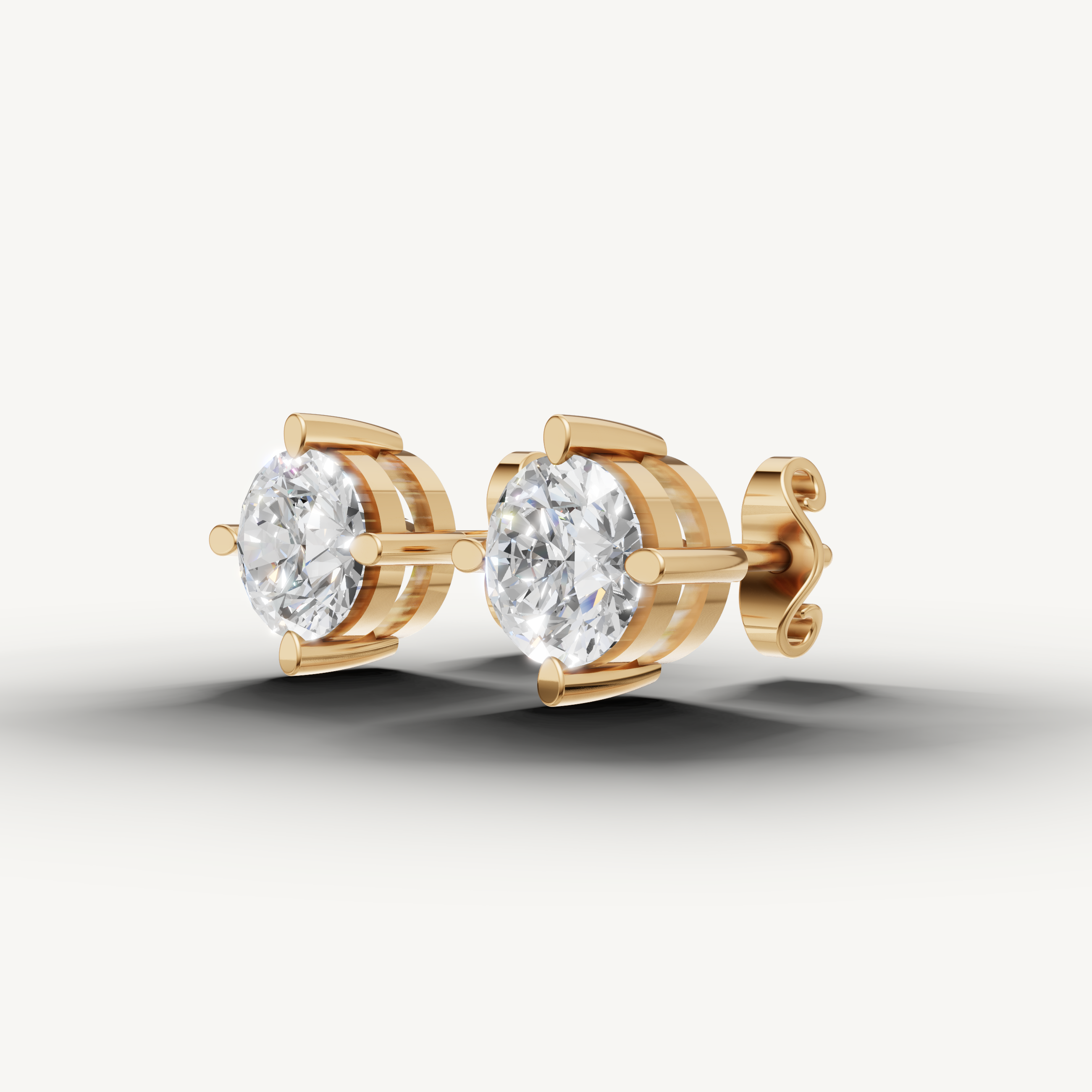 Raul Diamonds yellow gold four prong diamond stud earrings with sparkling round brilliant diamonds
