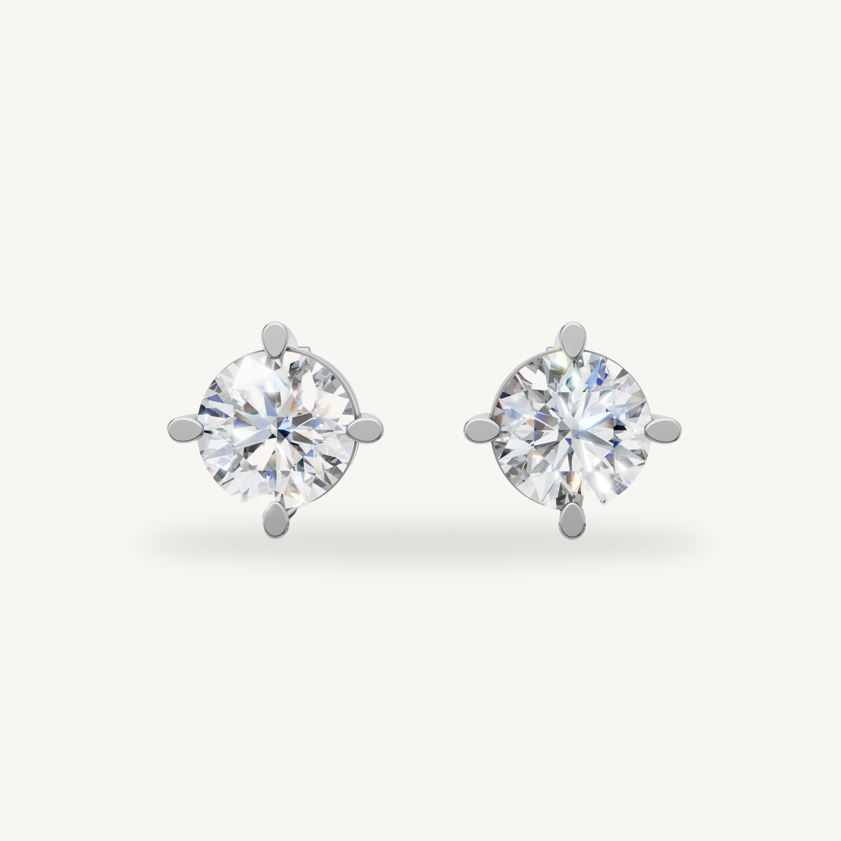 Raul Diamonds white gold round diamond stud earrings with classic four prong solitaire setting