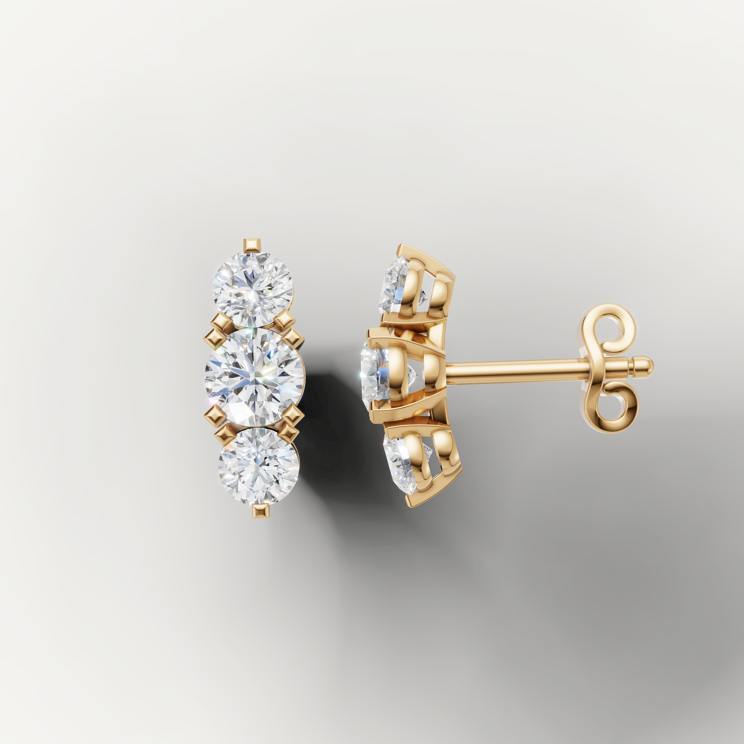 Yellow gold three stone diamond earrings by Raul Diamonds with elegant brilliance