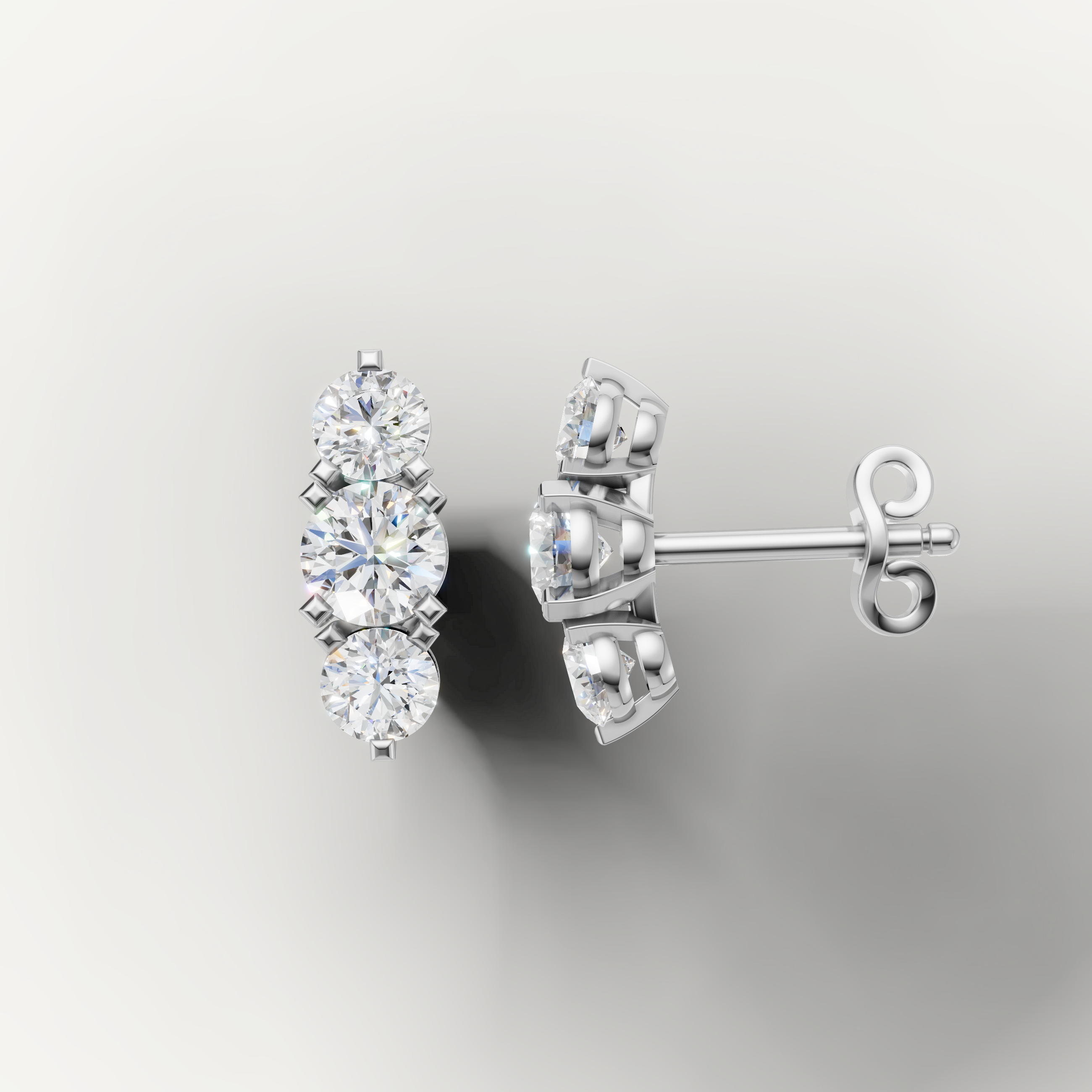 White gold three stone diamond earrings by Raul Diamonds with timeless elegance