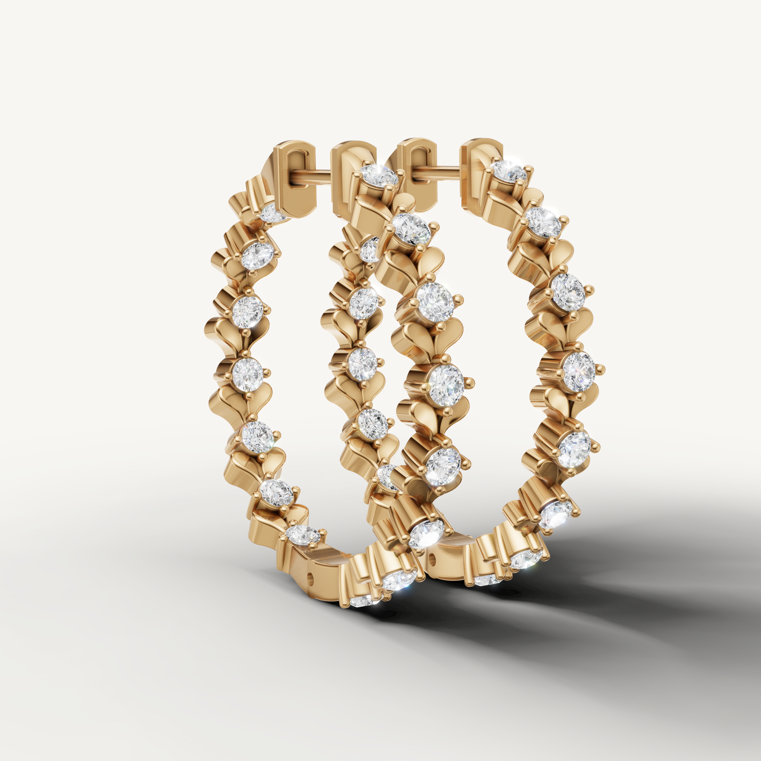 Yellow gold diamond hoop earrings by Raul Diamonds with elegant floral pattern
