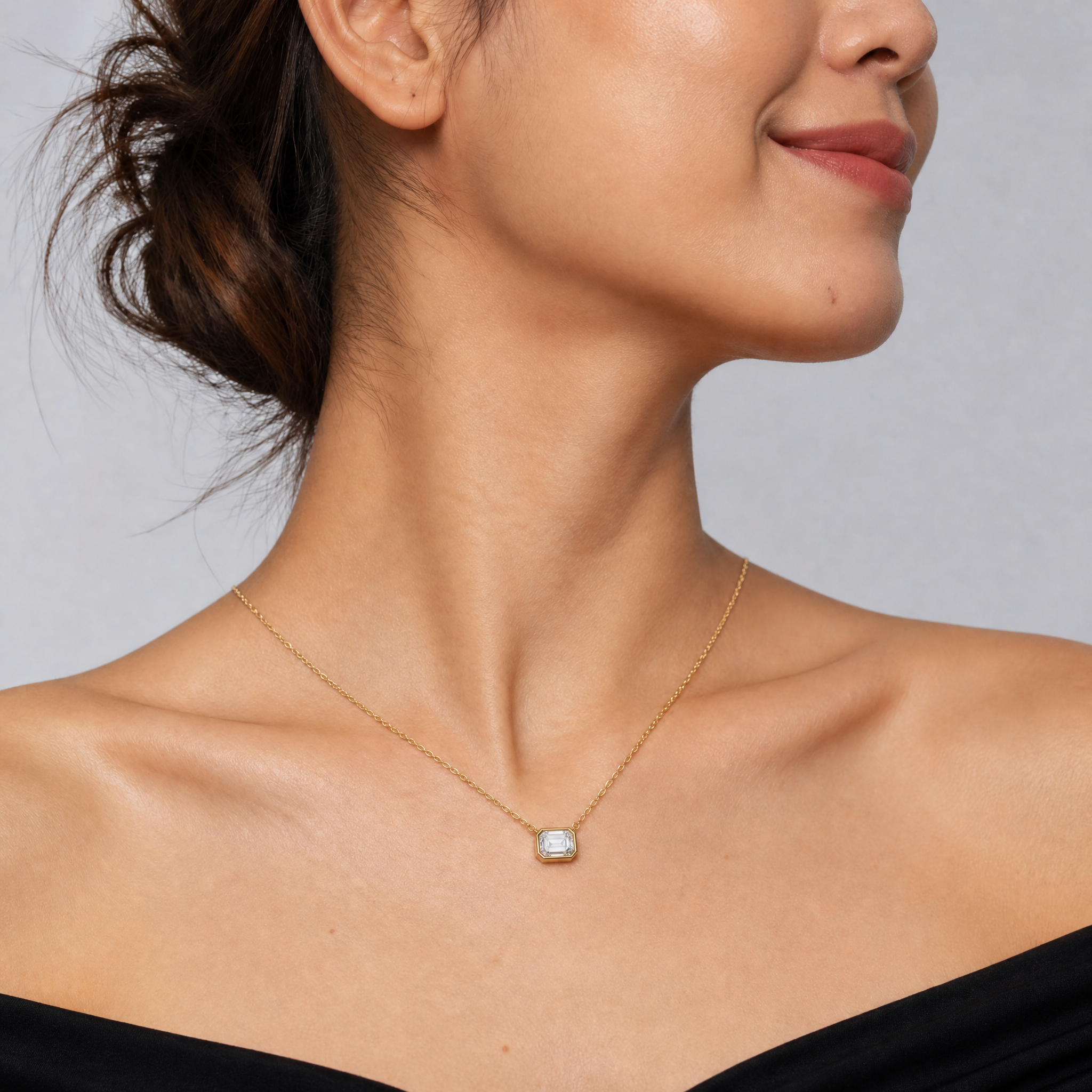 Female Model Wearing Emerald Cut Bezel Lab Grown Diamond Pendant Necklace in 14K Gold by Raul Diamonds
