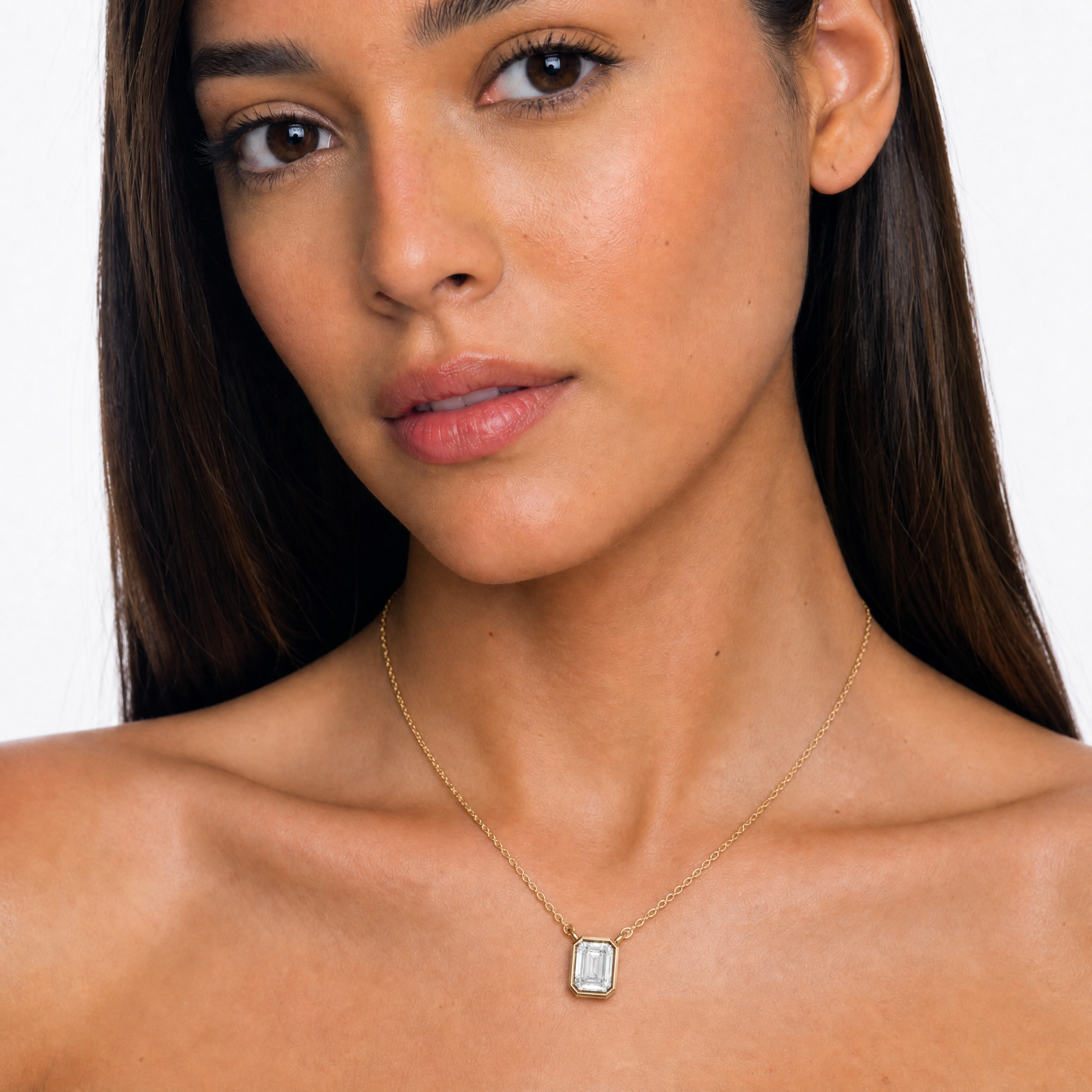 Female Model Wearing Emerald Cut Lab Grown Diamond Bezel Pendant Necklace in 14K Gold by Raul Diamonds