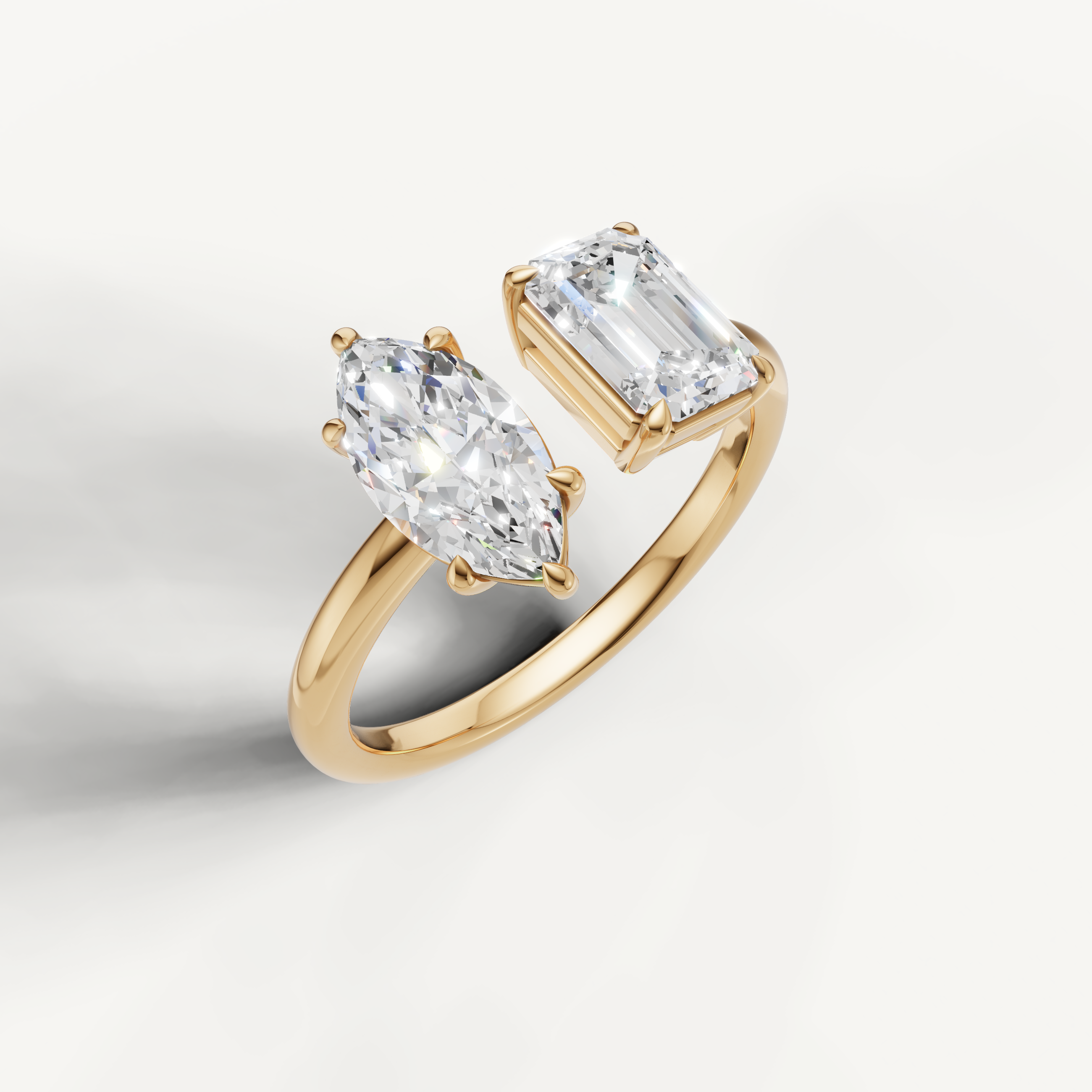 Luxury yellow gold toi et moi diamond ring featuring marquise and emerald cut solitaire stones by Raul Diamonds