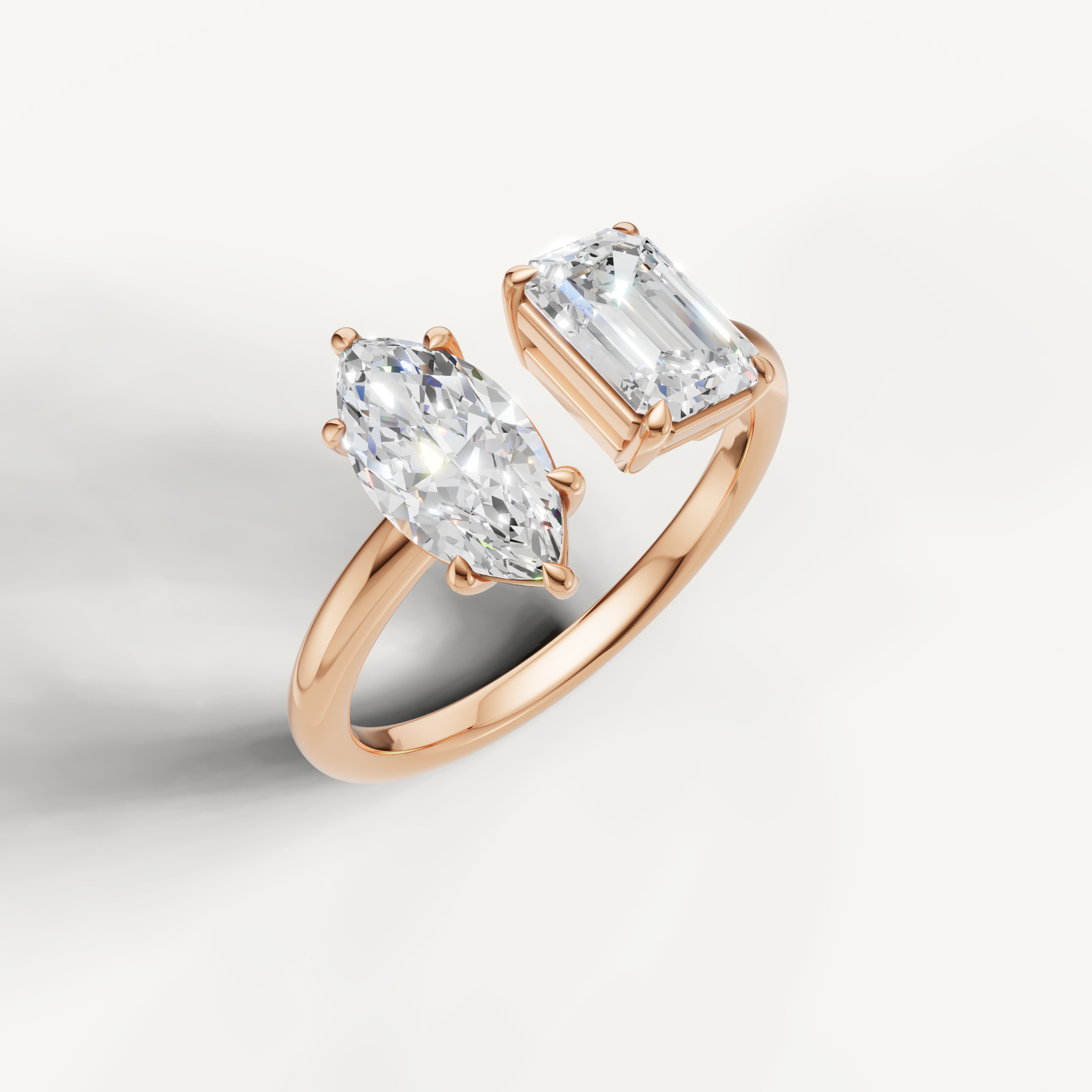 Romantic rose gold two stone diamond ring featuring marquise and emerald cuts by Raul Diamonds