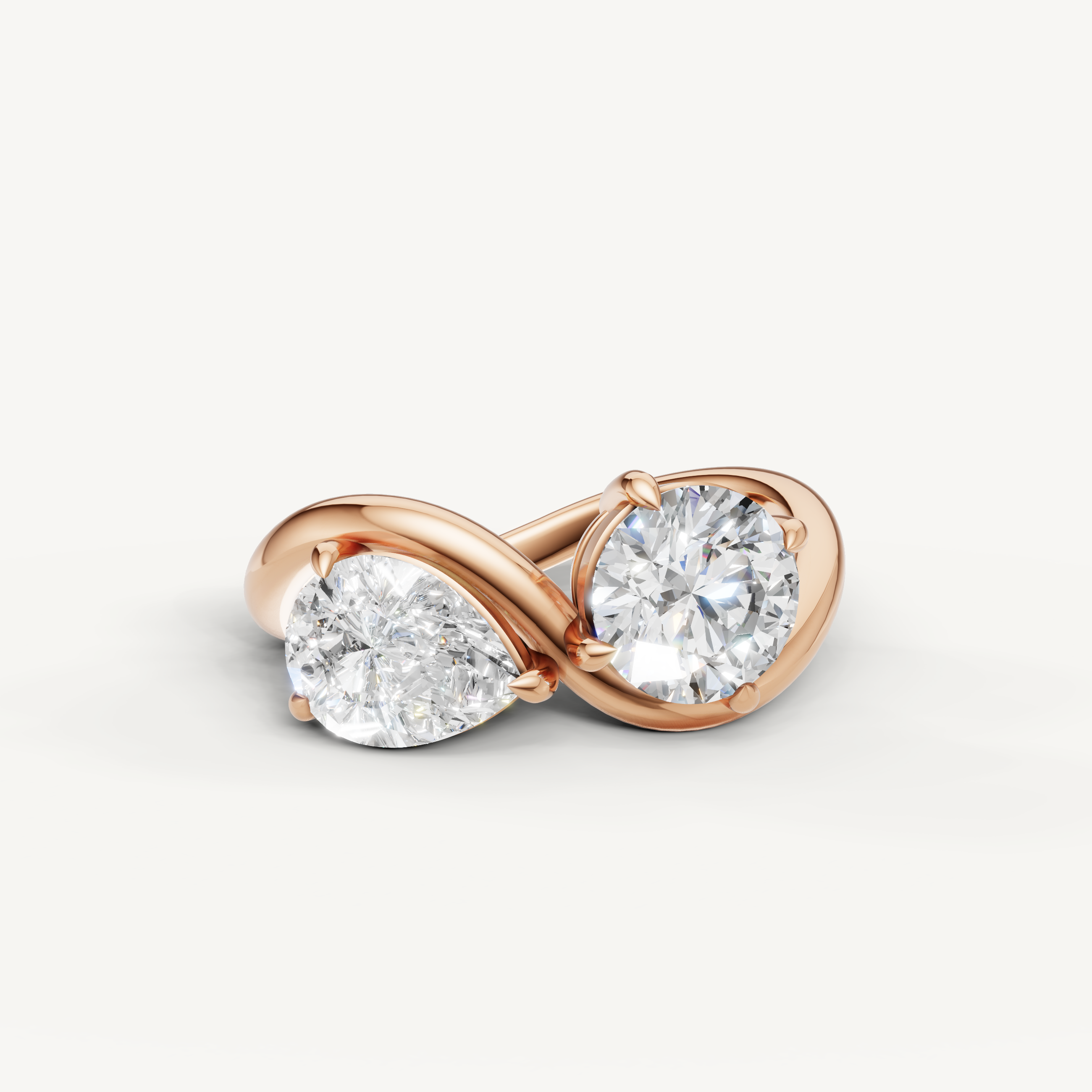 Raul Diamonds toi et moi engagement ring in rose gold with pear and round cut diamonds