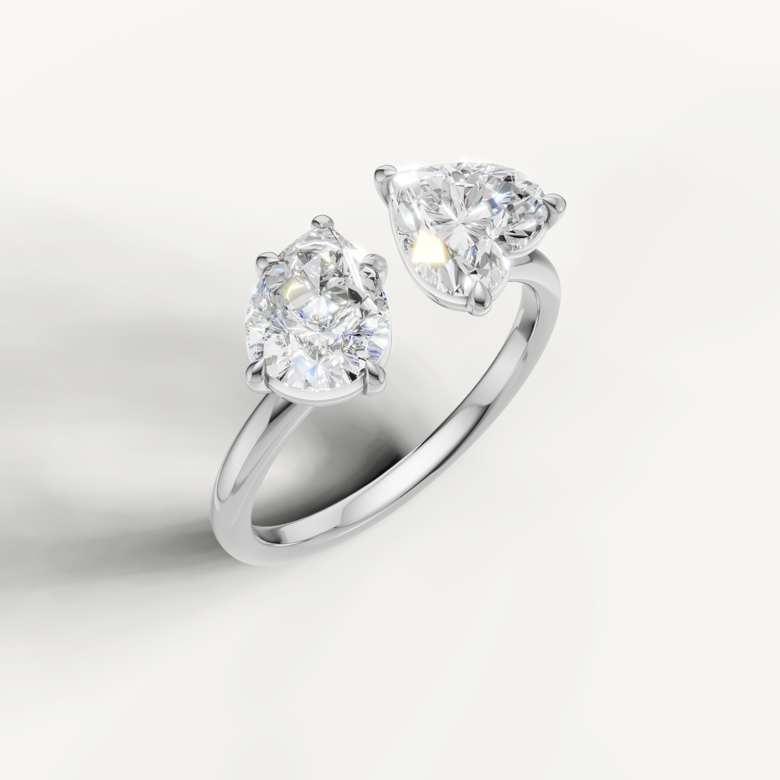 Modern white gold pear and emerald cut dual stone ring by Raul Diamonds