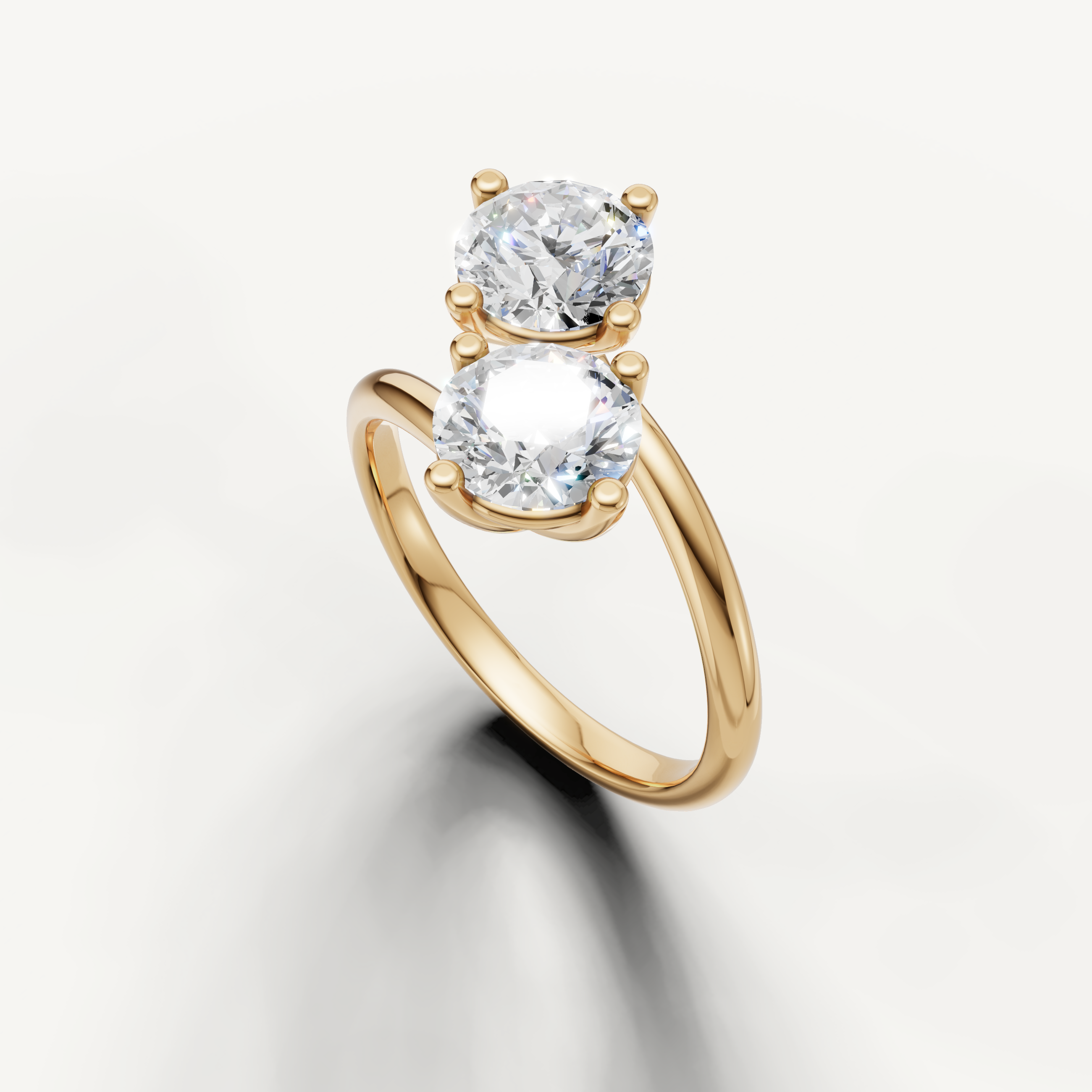Luxury yellow gold bypass diamond ring featuring two round solitaire stones from Raul Diamonds