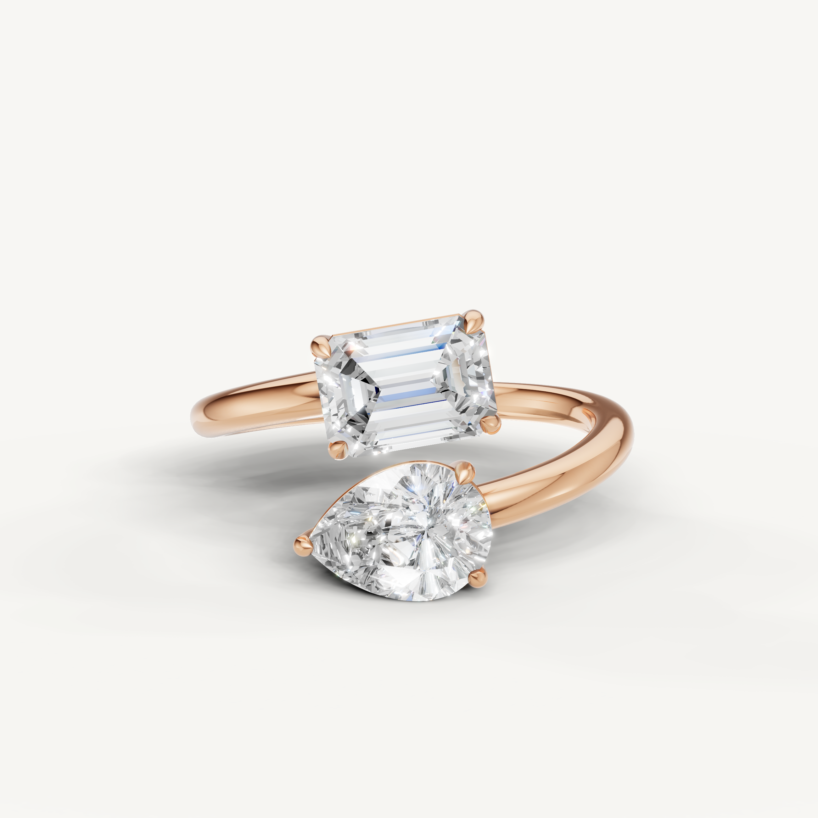 Raul Diamonds rose gold bypass engagement ring with emerald cut and pear shaped lab diamonds