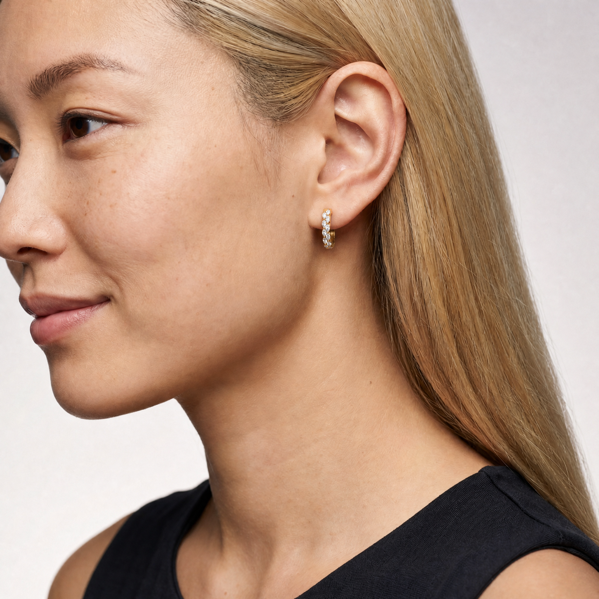 Elegant model wearing Raul Diamonds marquise diamond hoop earrings with luxurious contemporary styling