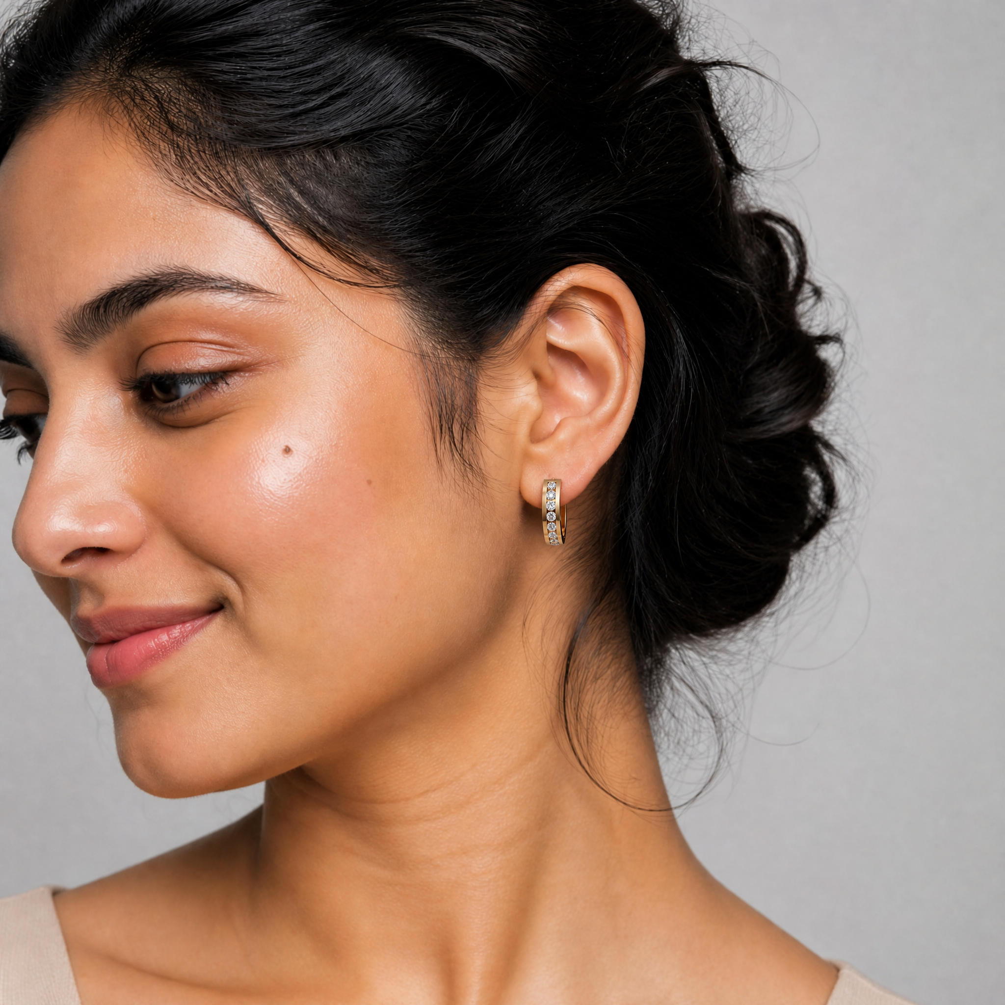 Stylish model wearing Raul Diamonds diamond hoop huggie earrings with luxury modern sparkle