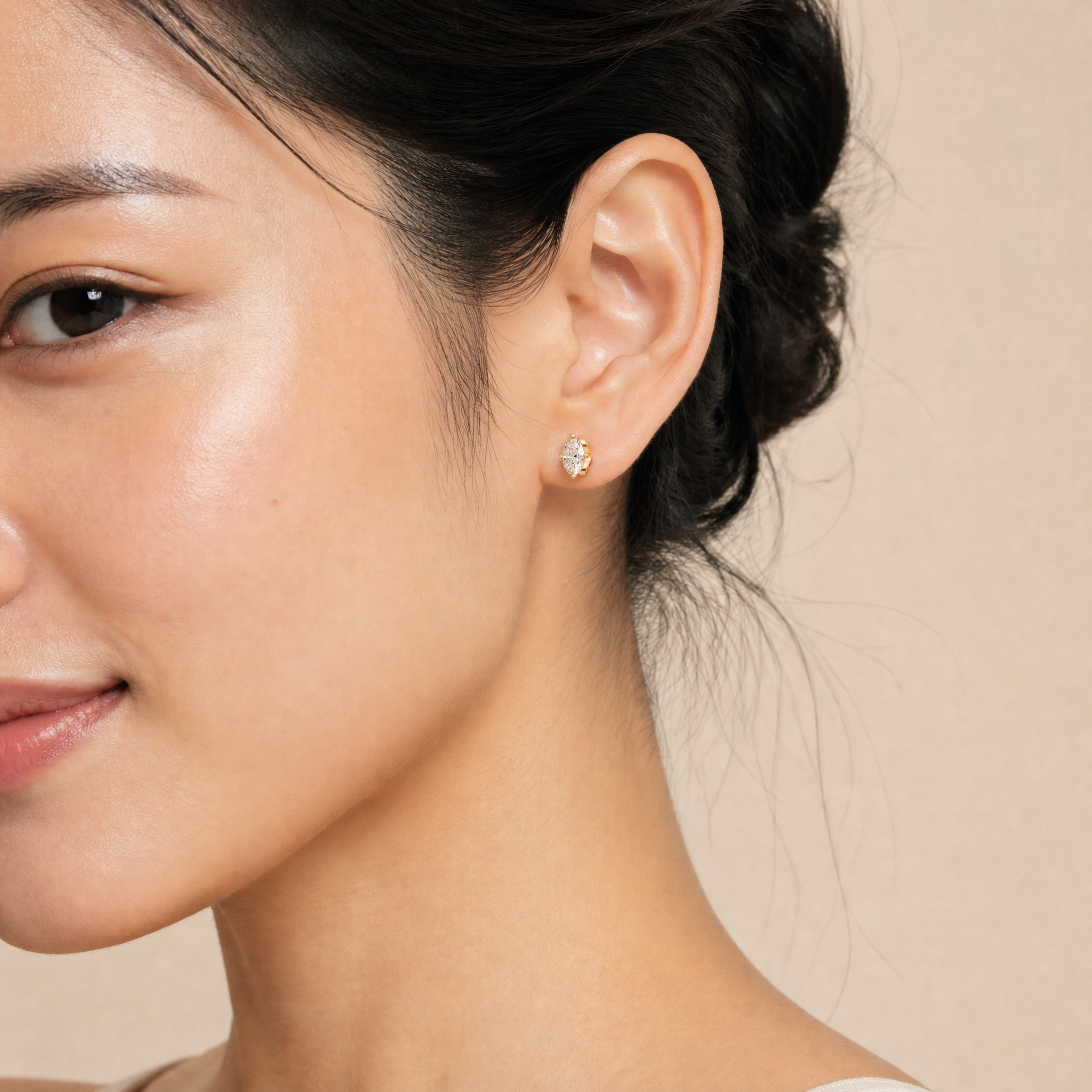 Elegant model wearing Raul Diamonds marquise diamond stud earrings with timeless luxury sparkle