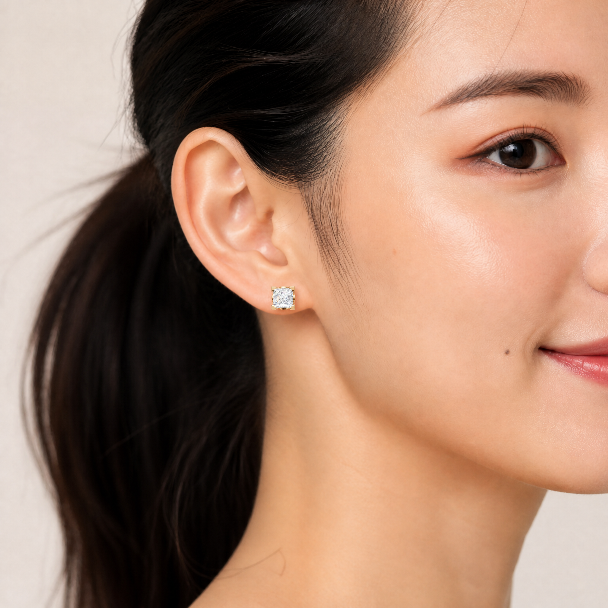 Elegant model wearing Raul Diamonds princess cut diamond stud earrings with luxury sparkle