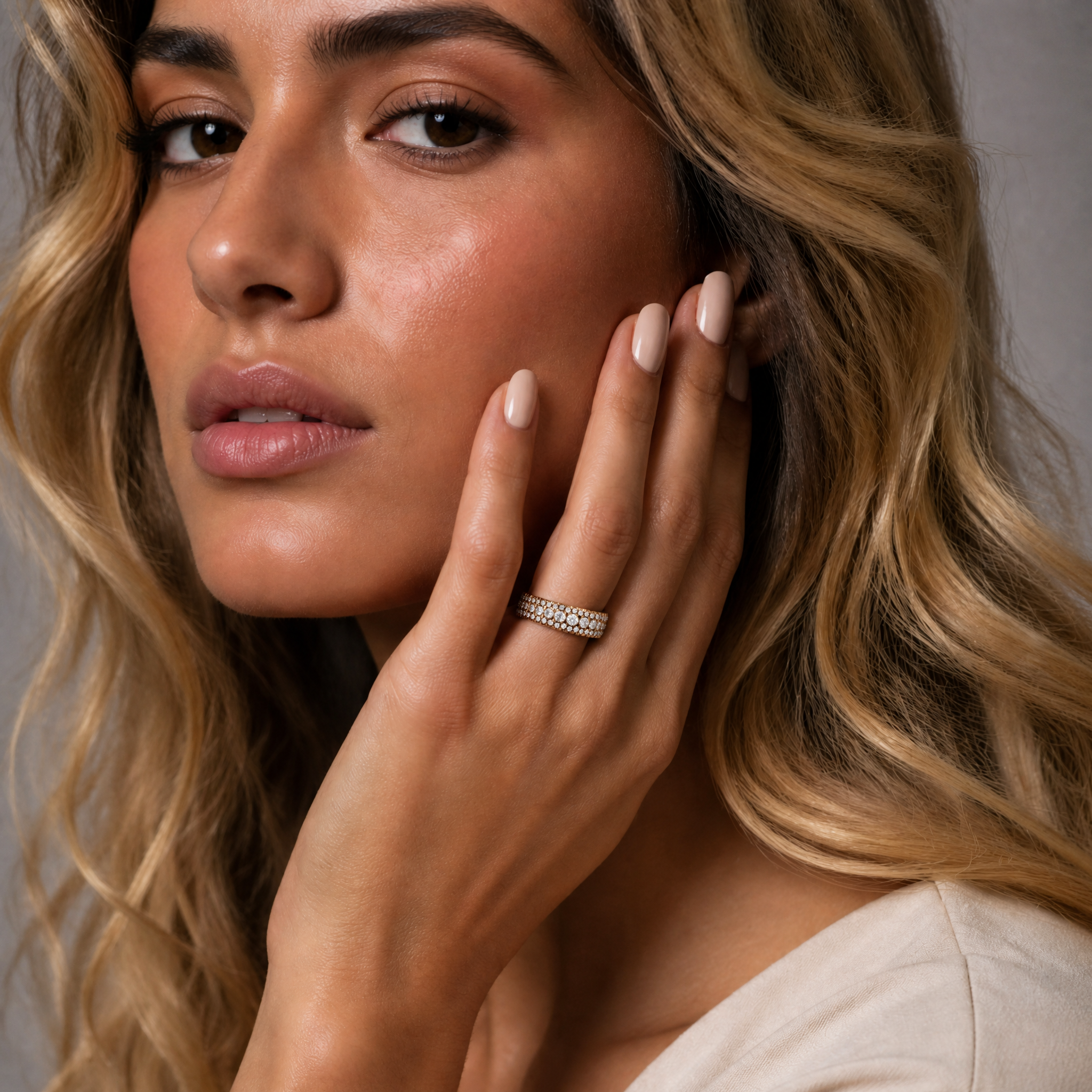 Female model wearing Raul Diamonds yellow gold pavé diamond wedding band with elegant luxury bridal styling