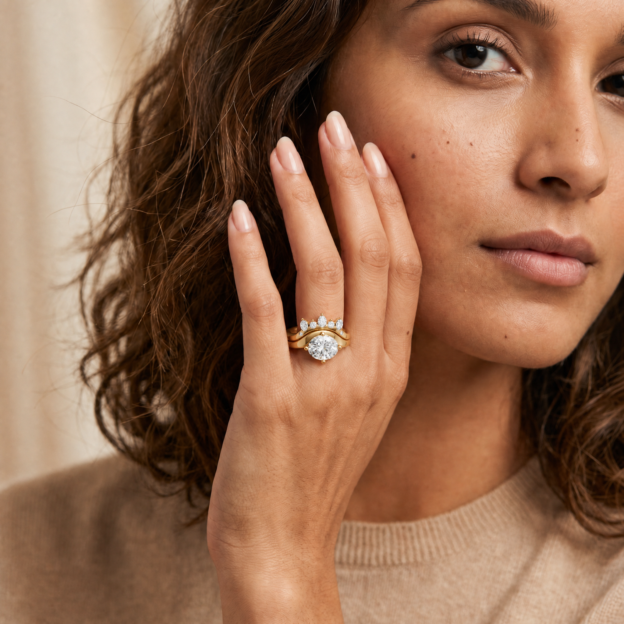 Model wearing Raul Diamonds yellow gold oval cut lab grown diamond engagement ring set with curved wedding band and marquise diamond accents for women