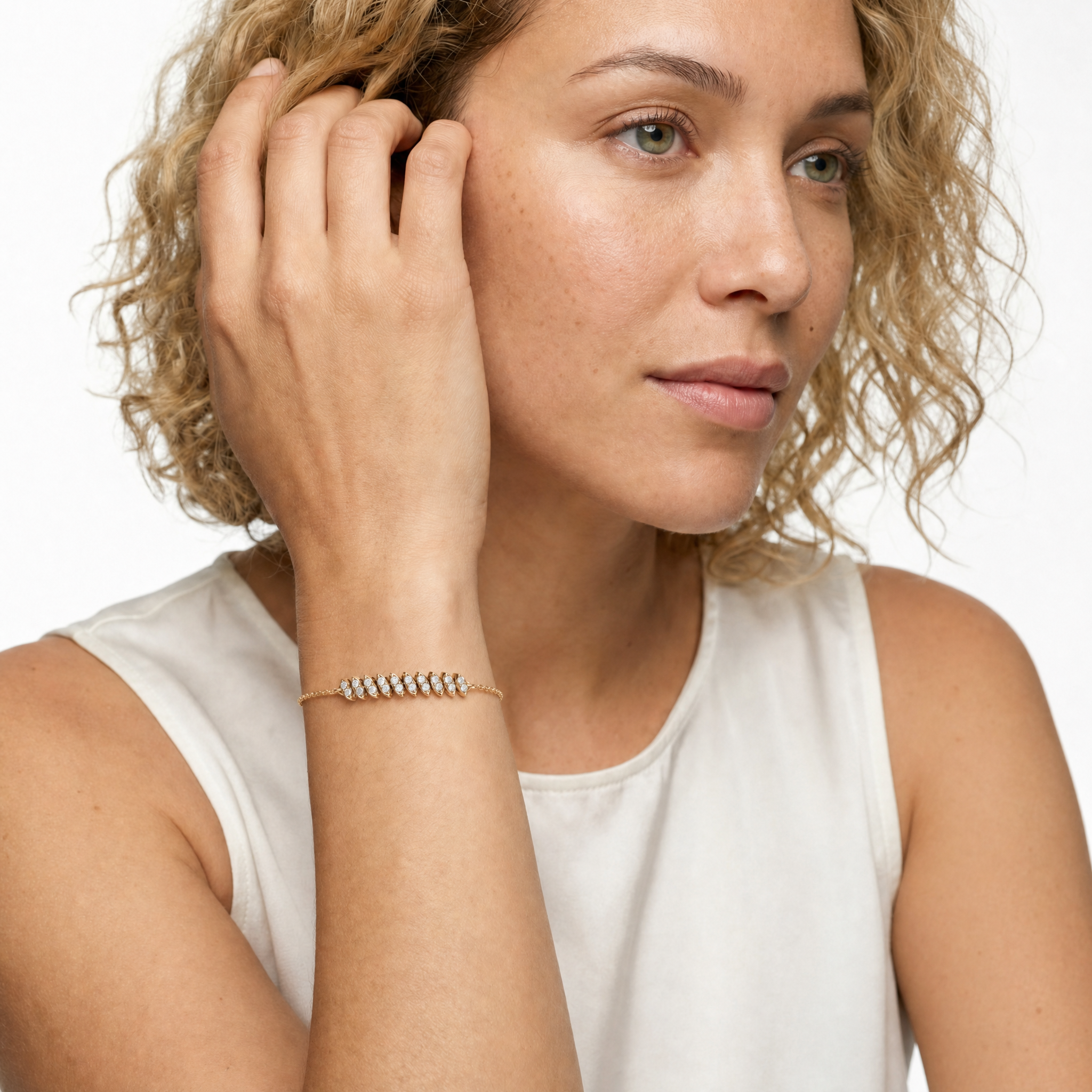 Model wearing Raul Diamonds yellow gold round lab grown diamond bracelet with marquise inspired links and delicate chain design